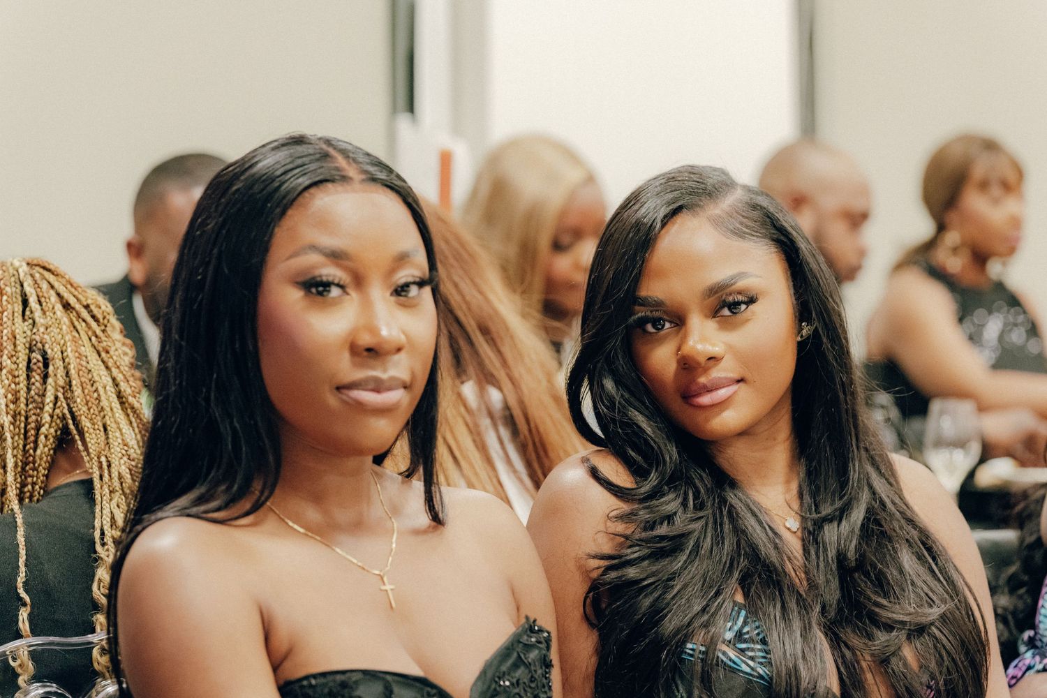 Two elegantly dressed attendees at a formal event.