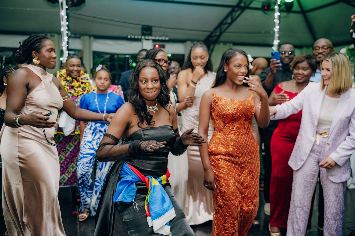 Guests dancing and celebrating at an elegant evening wedding reception.