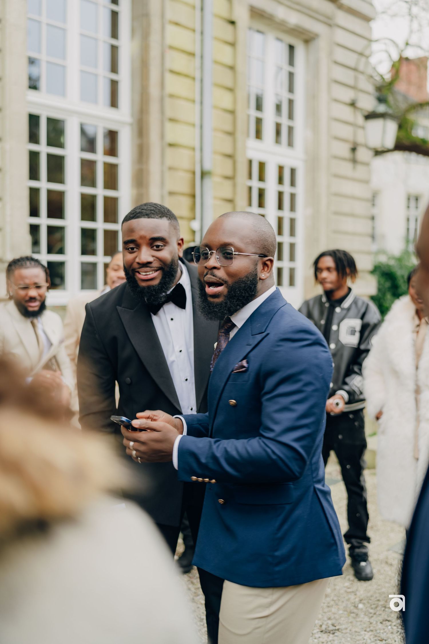Friends sharing laughs and conversation during outdoor wedding festivities.