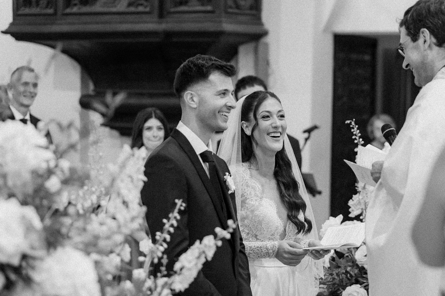 A collage of black and white wedding photos showing couples sharing joyful moments during their celebration.