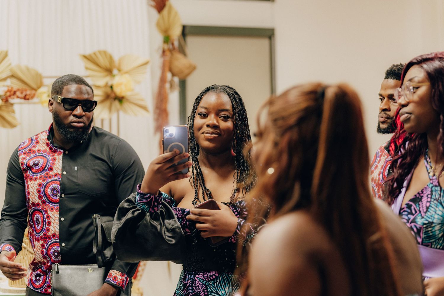 A lively party scene with people socializing and mingling at an indoor celebration event.