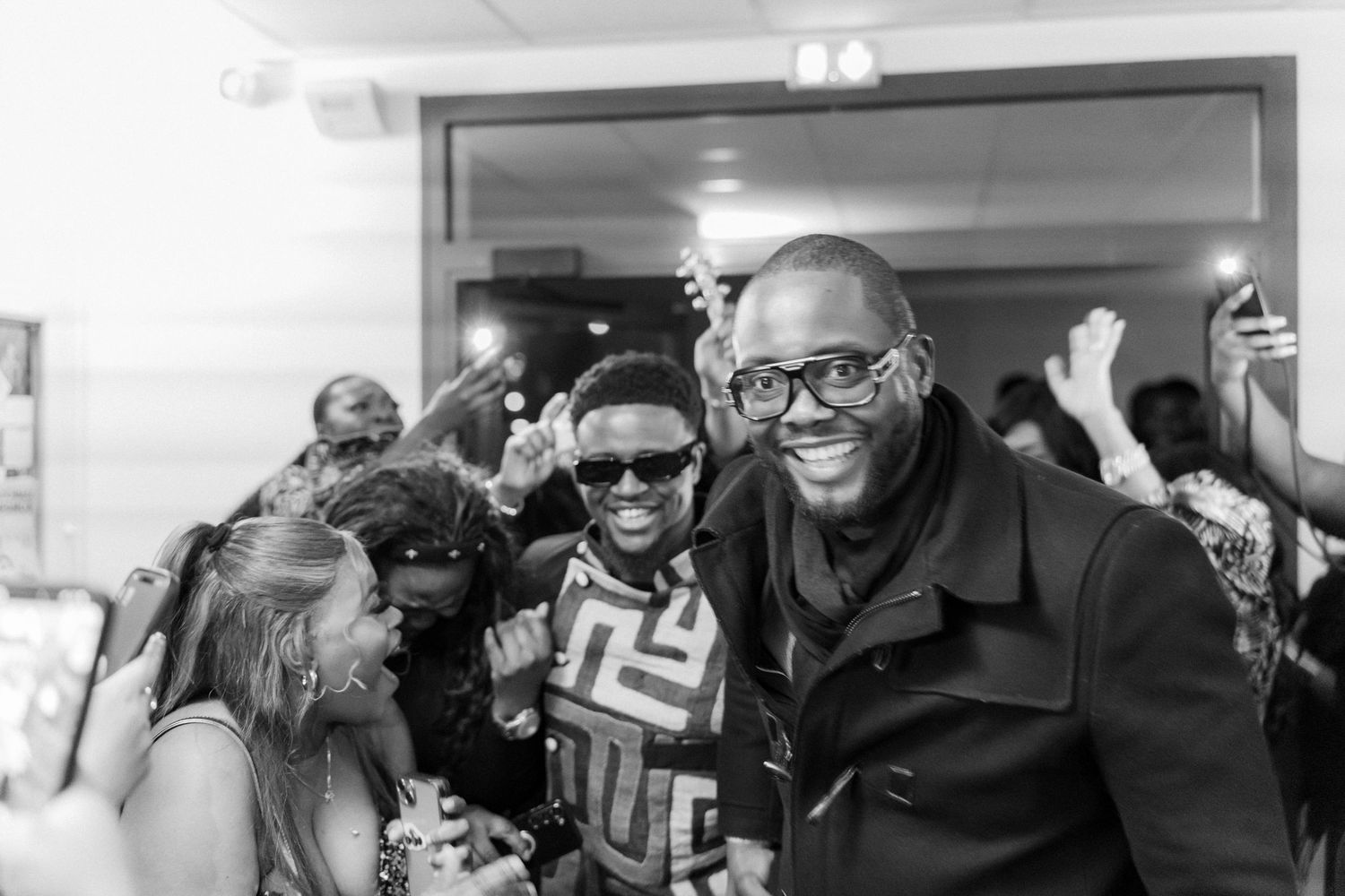 People celebrate together at an indoor gathering with joyful expressions.