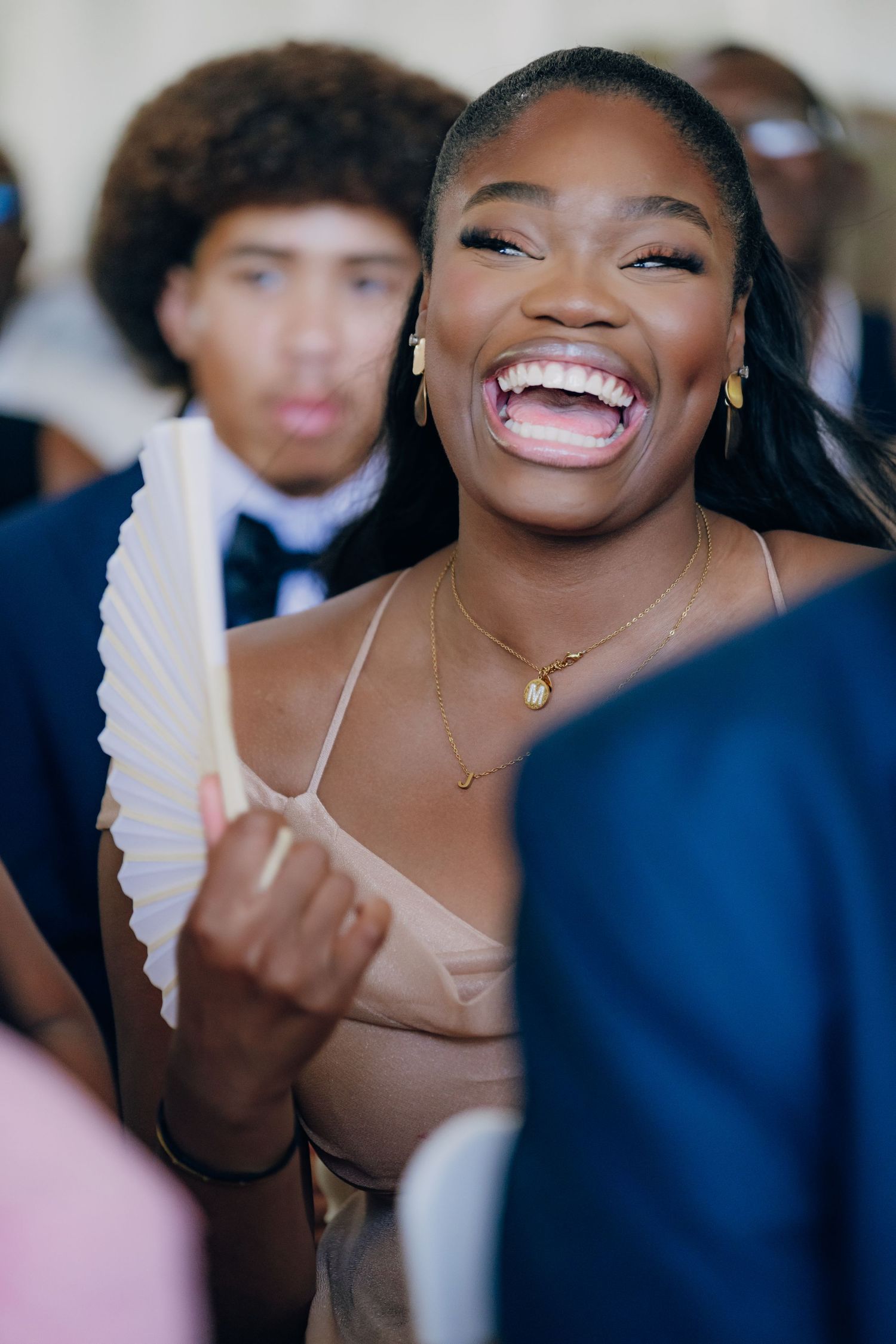 Candid moments of laughter and joy captured during a formal celebration.