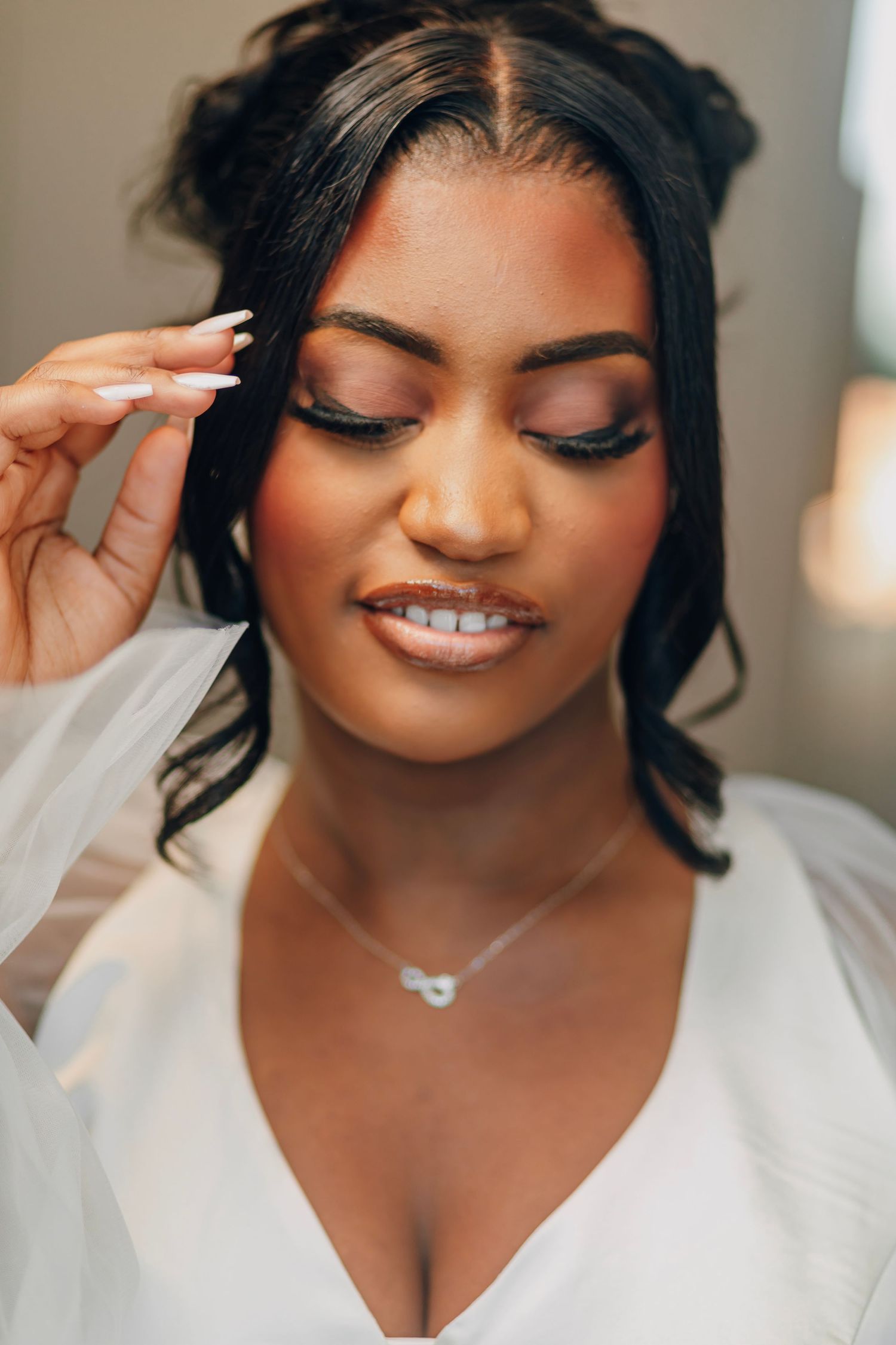 Elegant wedding day beauty shot showcasing soft makeup and a white v-neck neckline.