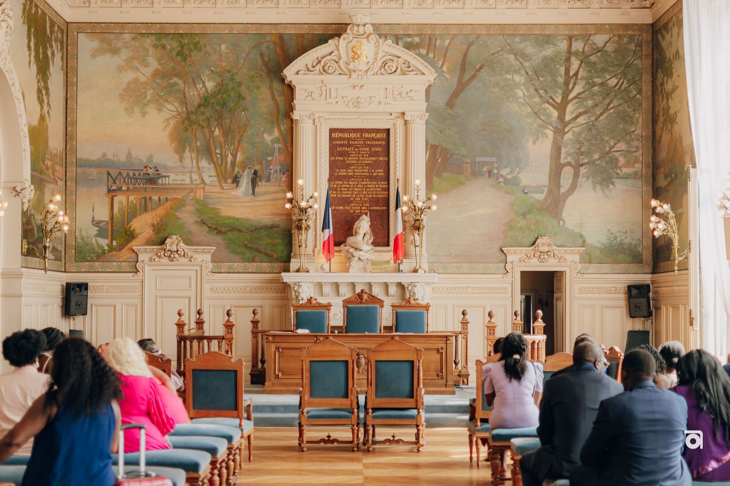 Historic chapel interior with ornate altar, murals, and blue chairs arranged for a ceremony.