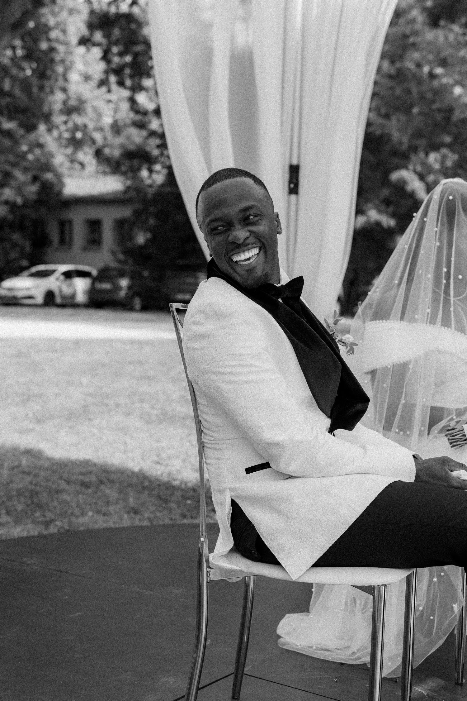 A black and white photo captures joyful moments at a wedding celebration.