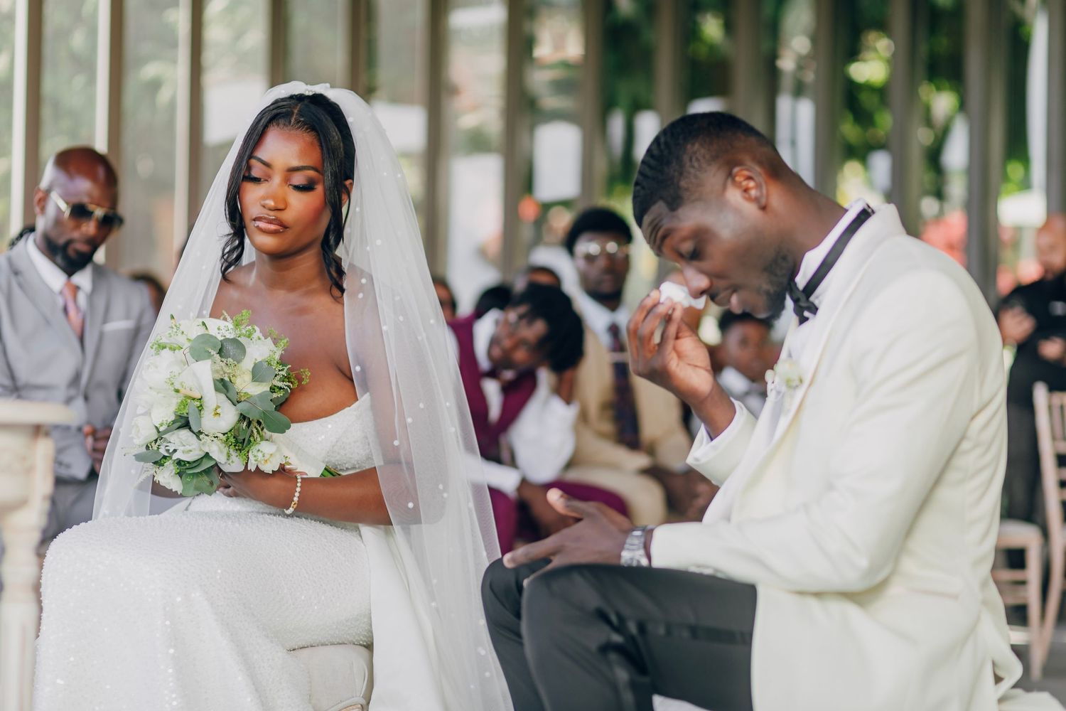 A couple shares an intimate moment during their outdoor wedding ceremony.