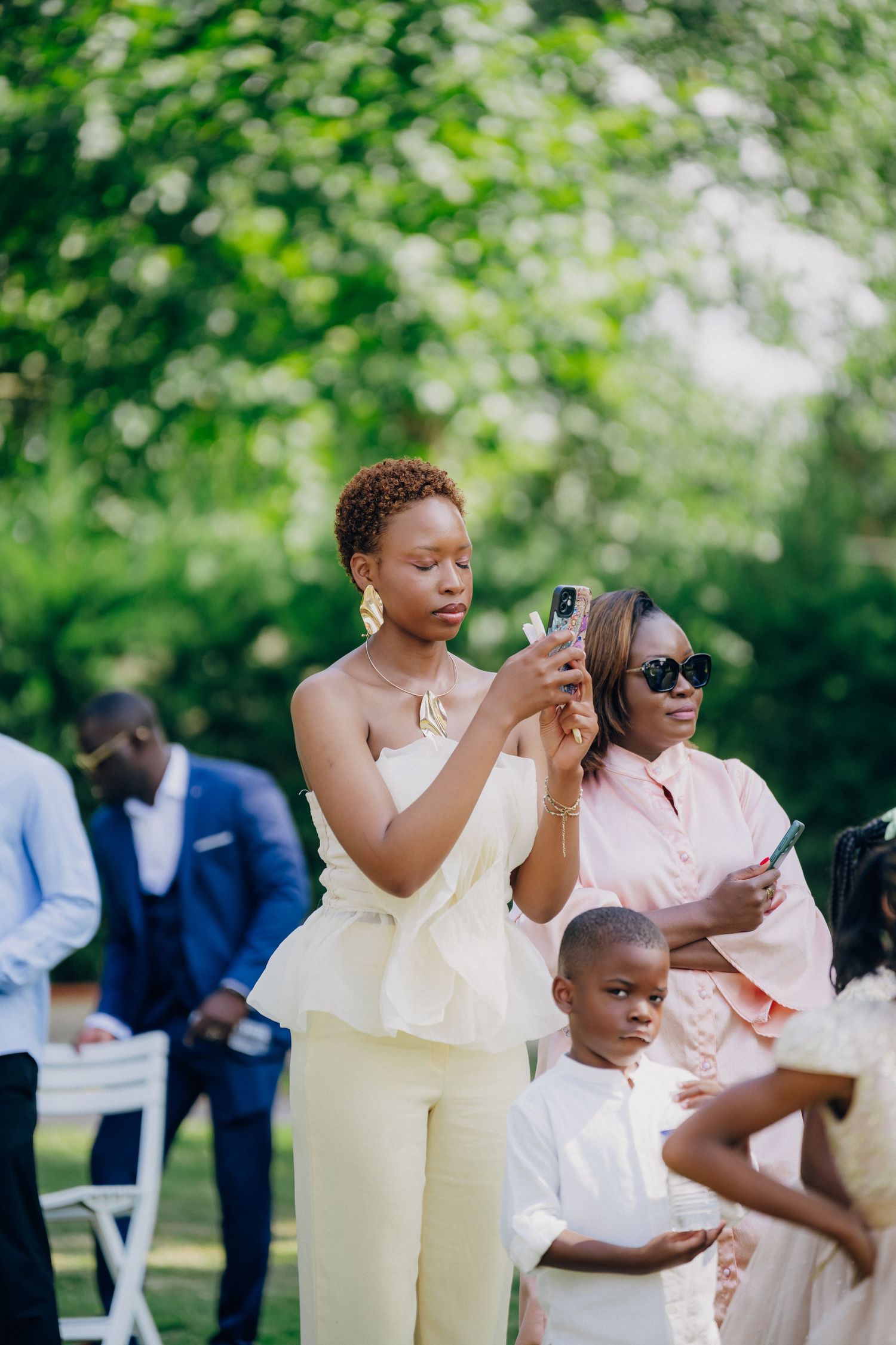 Wedding guests in pastel outfits enjoying themselves during an outdoor celebration.