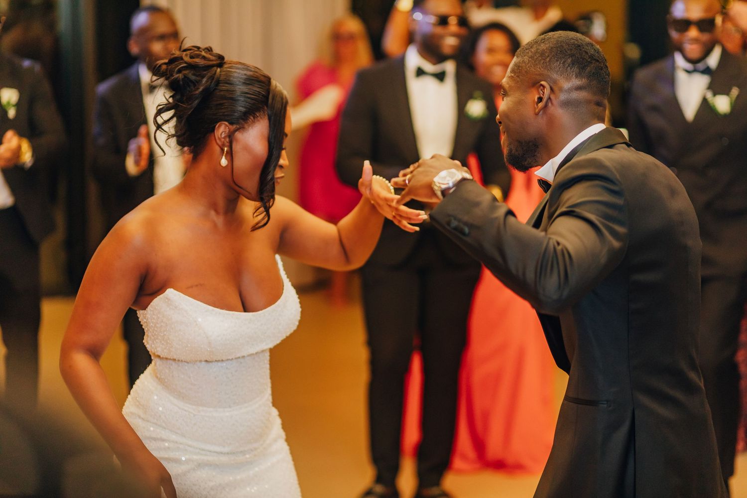 Dancing moment captured during wedding reception in elegant indoor venue.