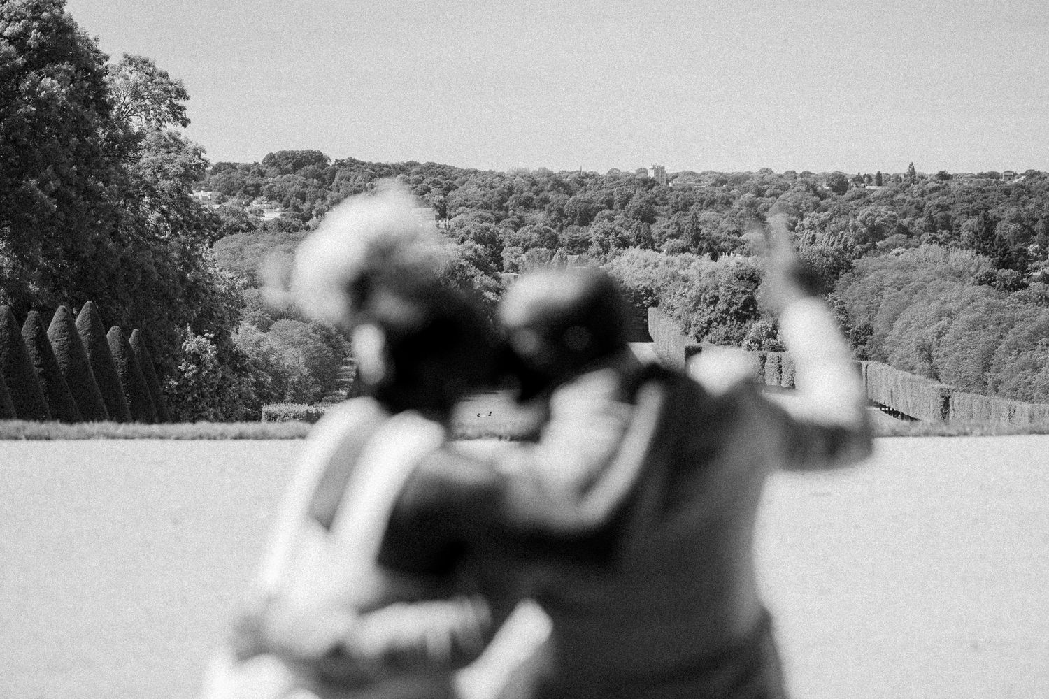 A sequence of black and white images showing a person taking aim with a rifle at an outdoor shooting range.