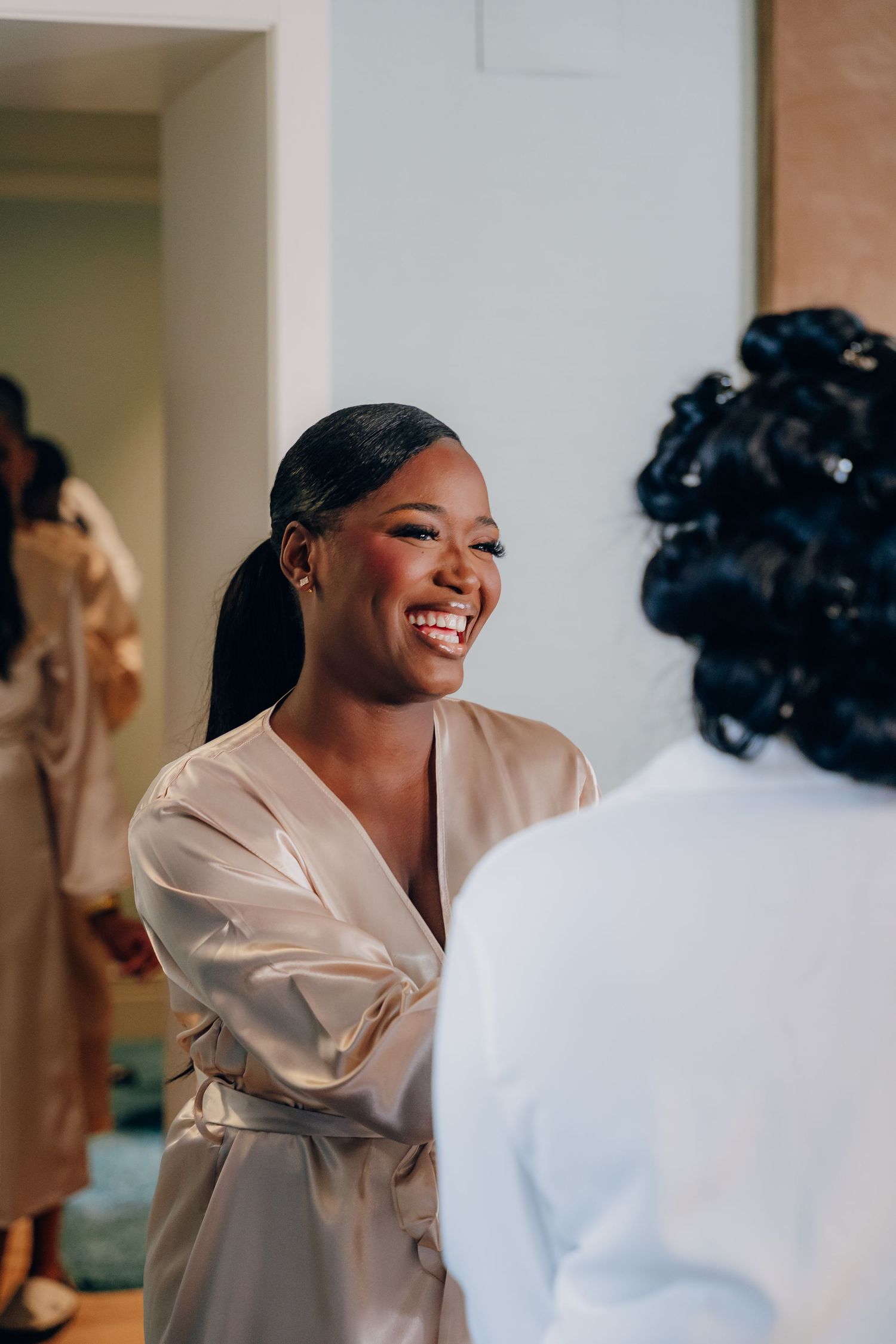 Wedding preparation moment captured in natural light with silk robes.