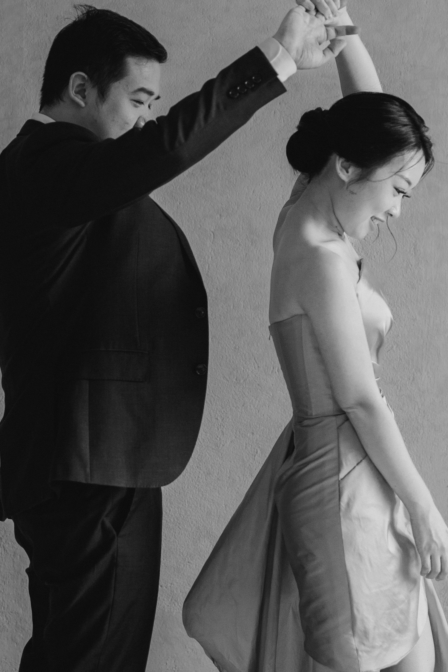 A black and white portrait of a dancing couple in formal attire.