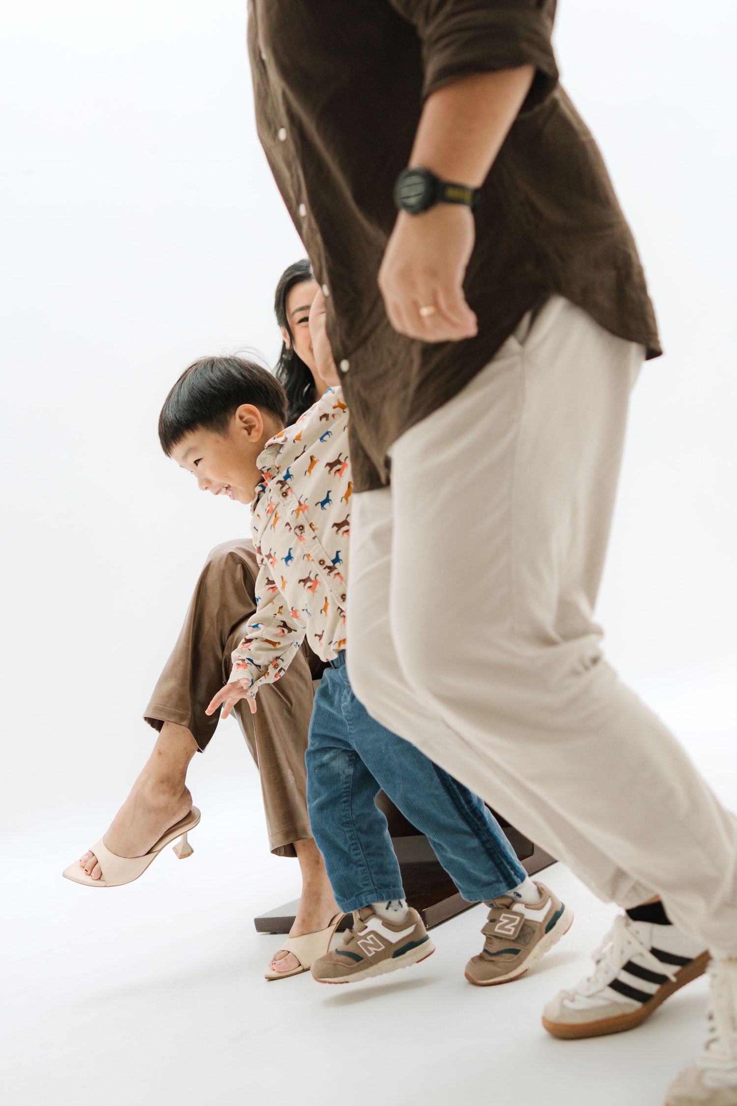 Creative studio portrait showing people's feet and legs against a white background.