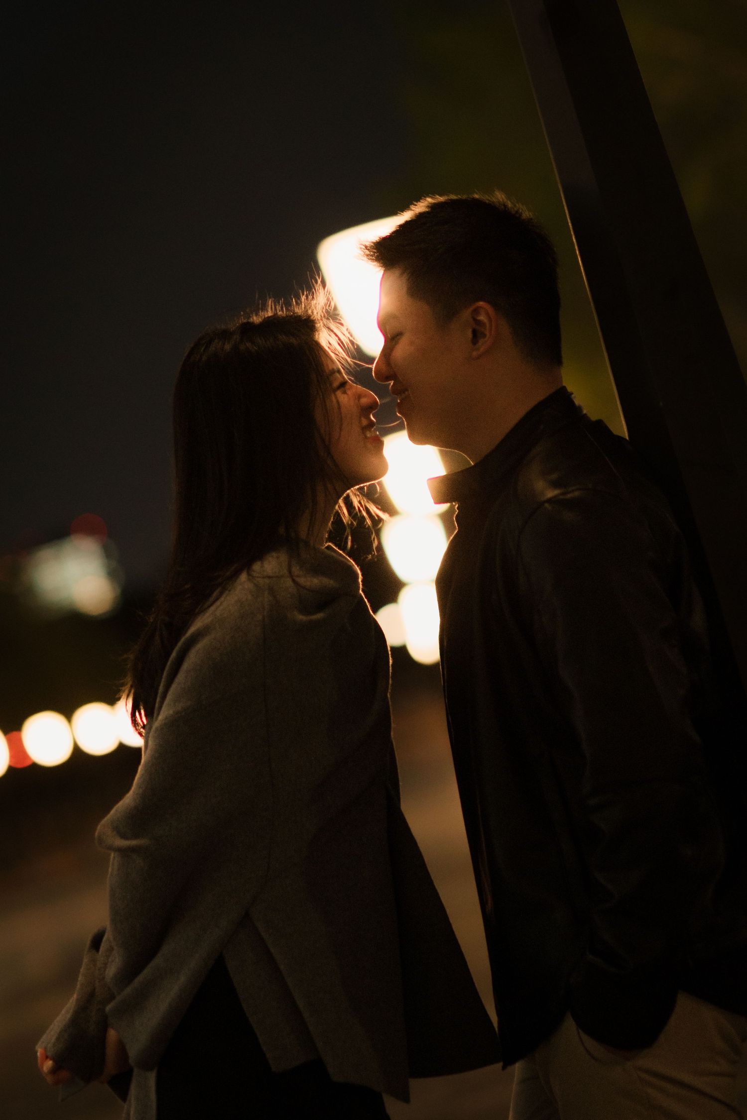 Intimate silhouette of couple in dramatic nighttime lighting.