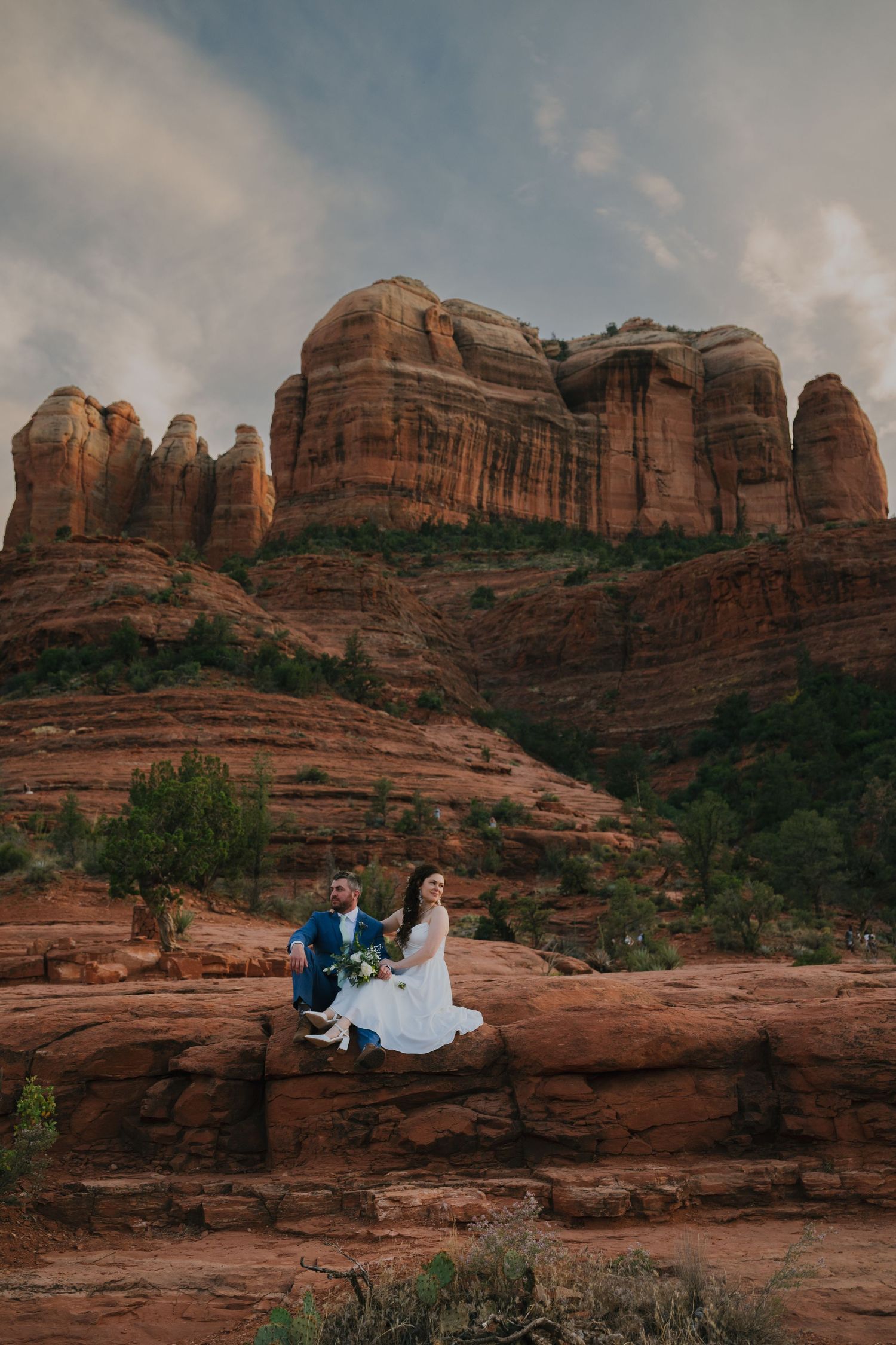Scenic red rock formations tower over desert landscape as sun sets in Sedona, Arizona during outdoor photoshoot session.