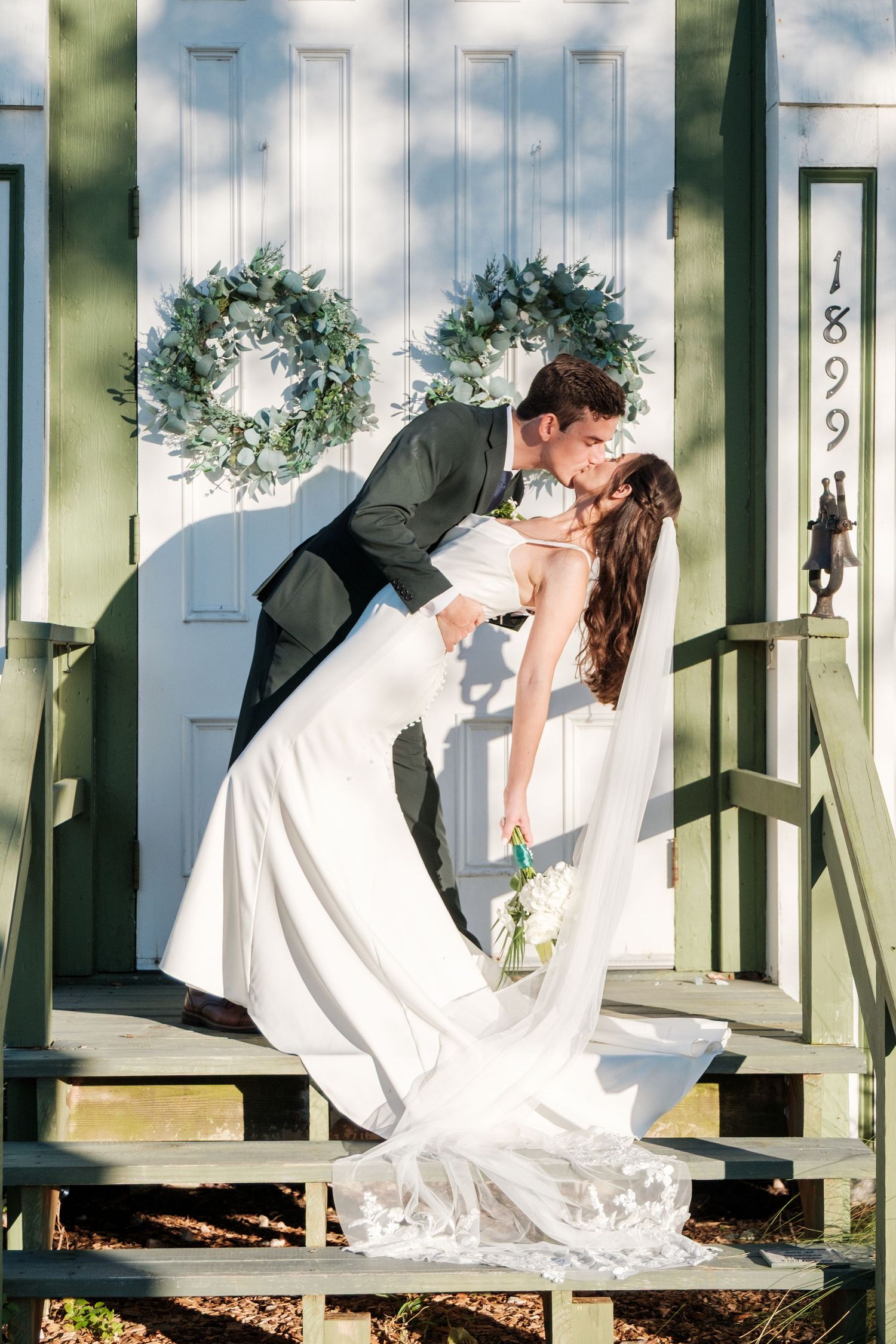 A series of romantic wedding photos showing a couple dipping and kissing on a white porch with green columns.