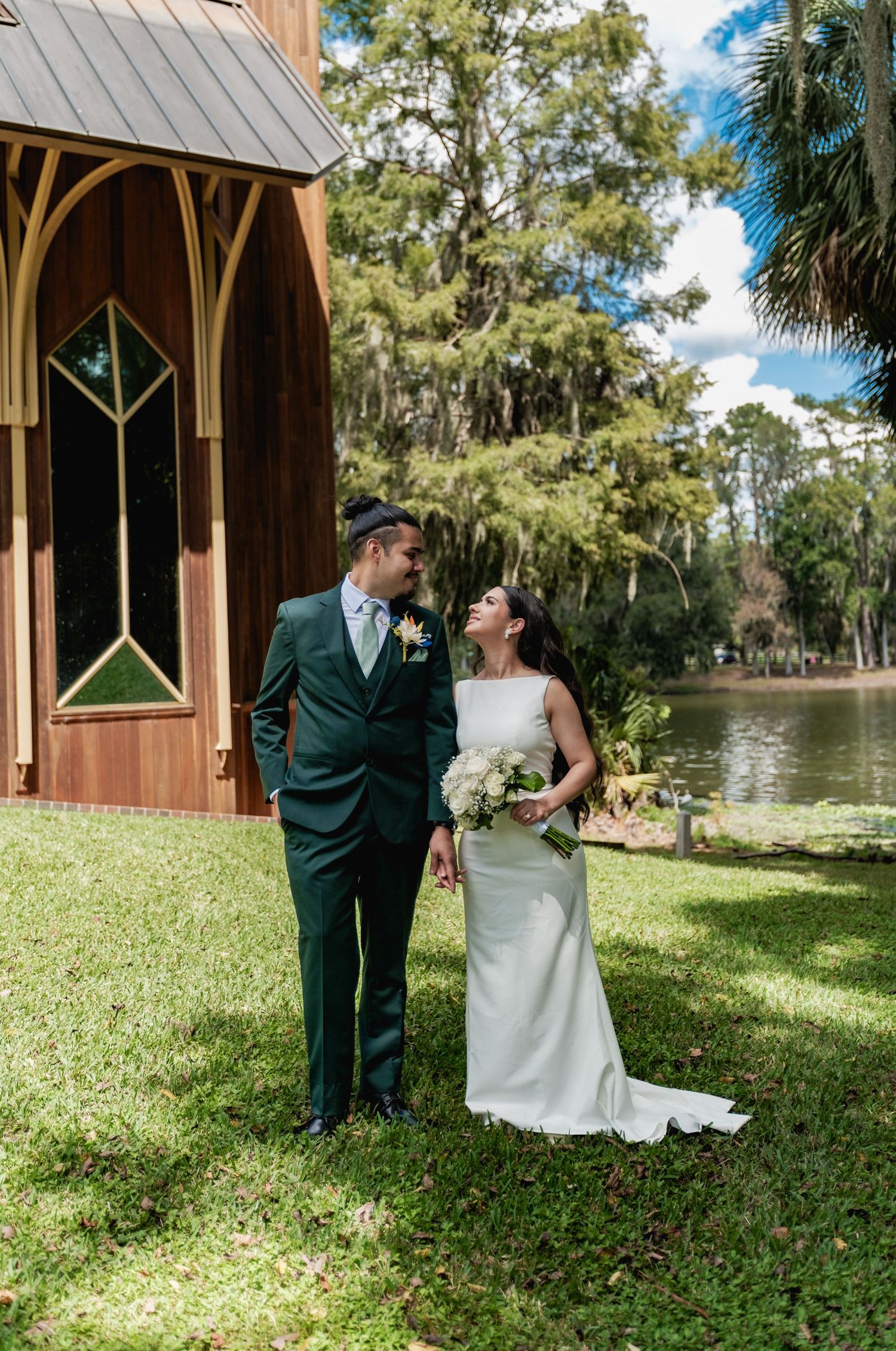 Candid wedding photos of a couple sharing joyful moments by a lakeside gazebo.