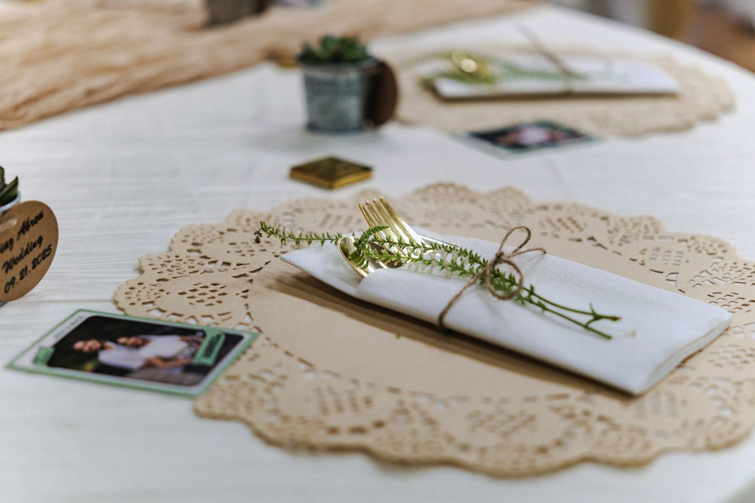 Elegant wedding stationery and decorative lace details arranged on a rustic wooden surface.