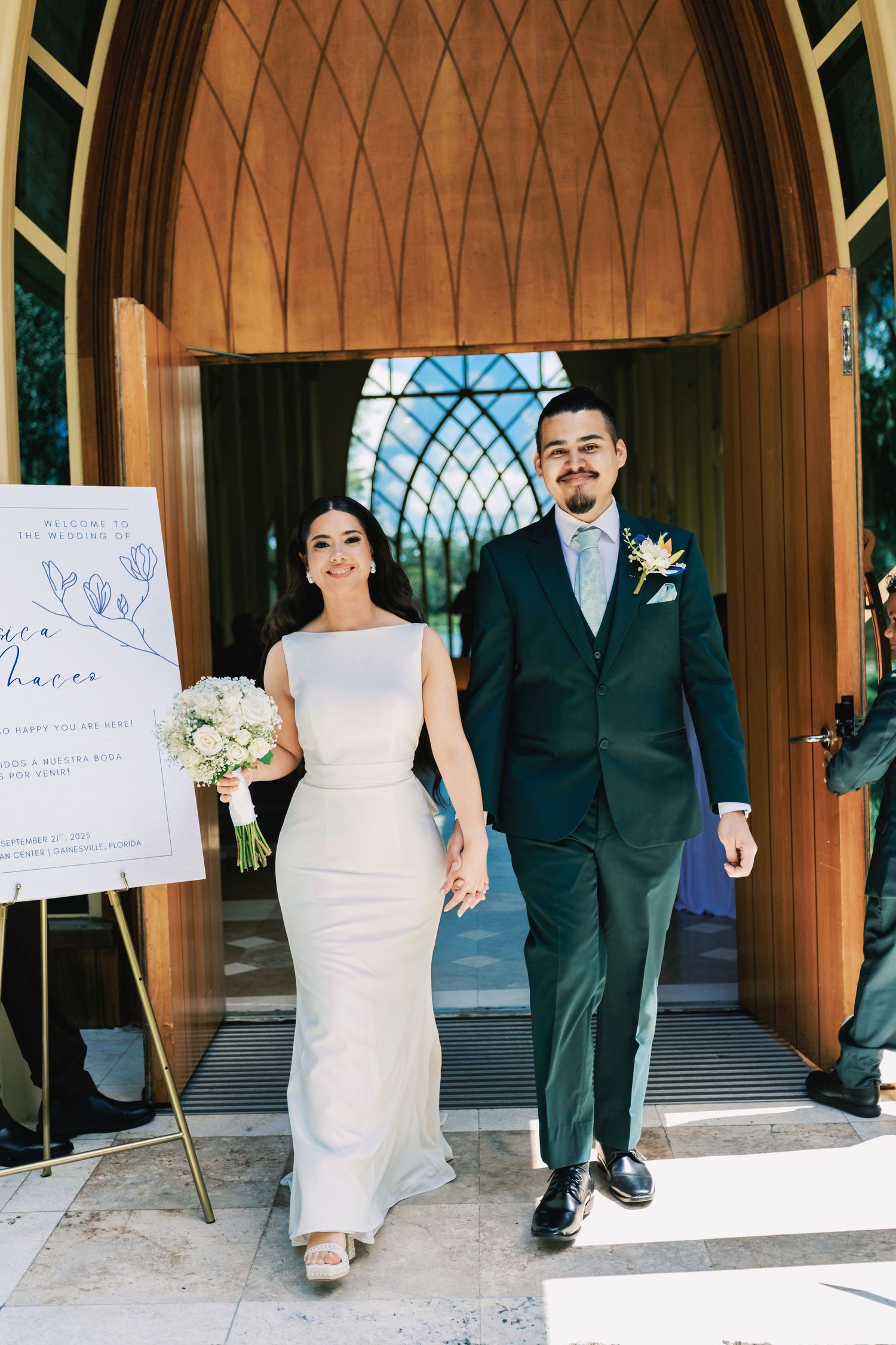 Wedding ceremony exit with decorative signs and wooden chapel architecture.