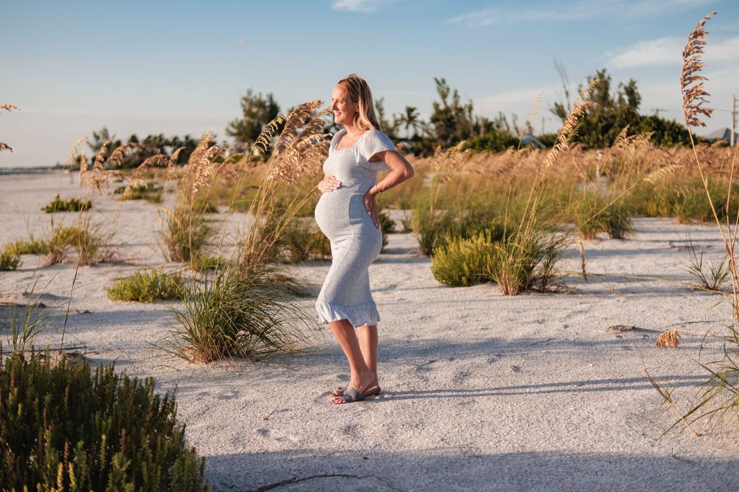 A sequence of photos showing a person in a white dress walking along a sandy beach at sunset.