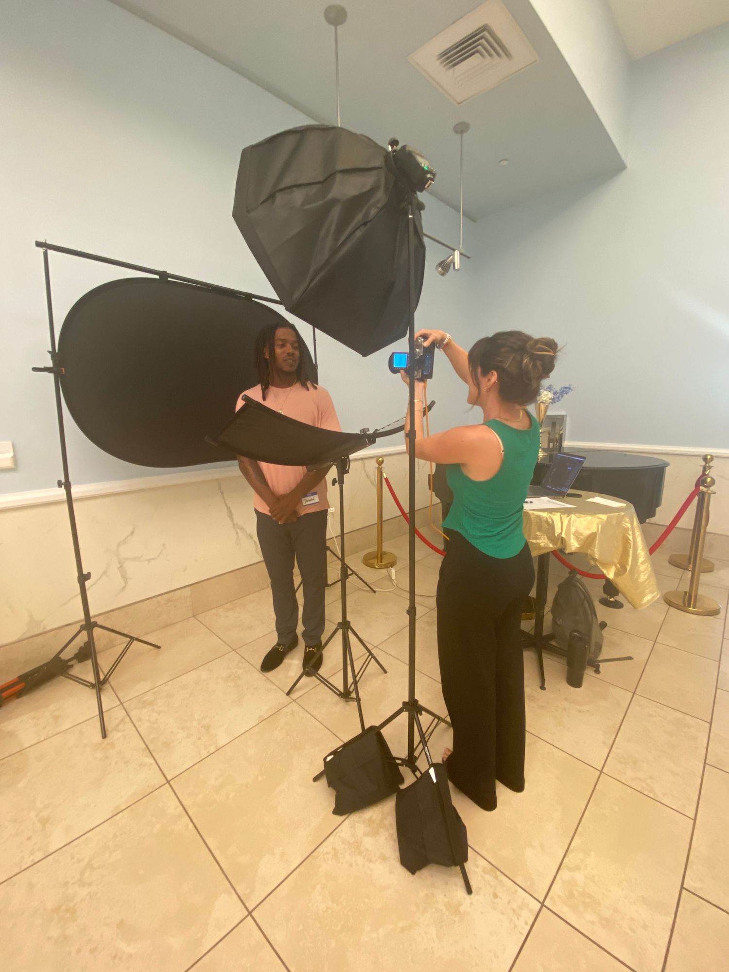 Photography setup with lighting equipment and softbox in a bright studio space.