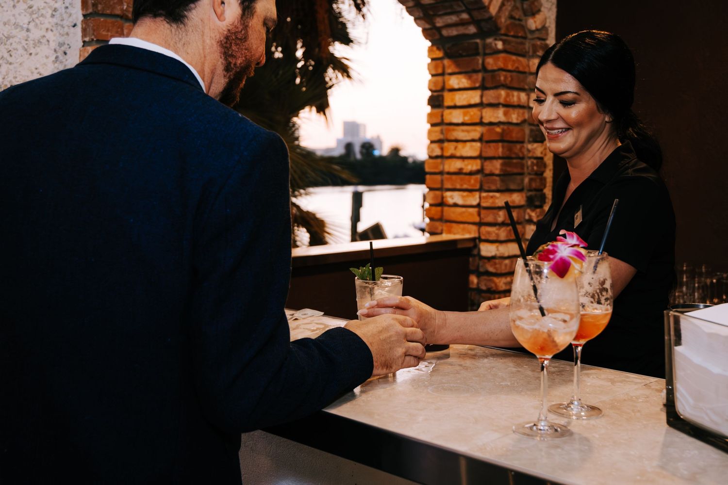 Candlelit wedding reception dinner with brick walls and intimate ambiance.