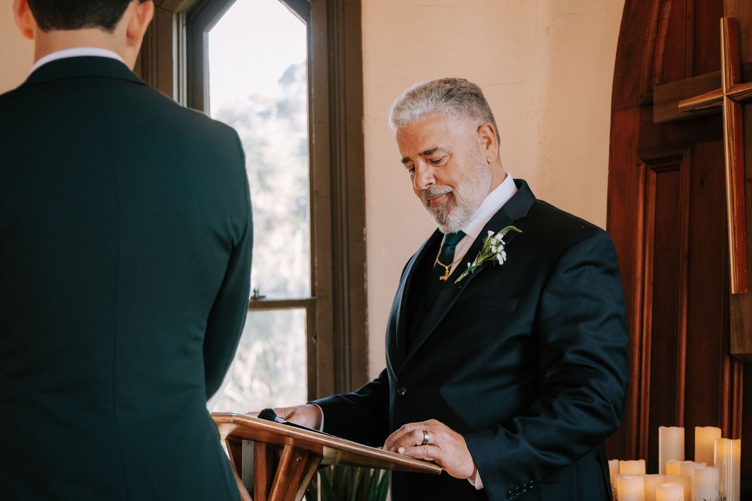 Emotional wedding ceremony moment captured in warm indoor lighting.