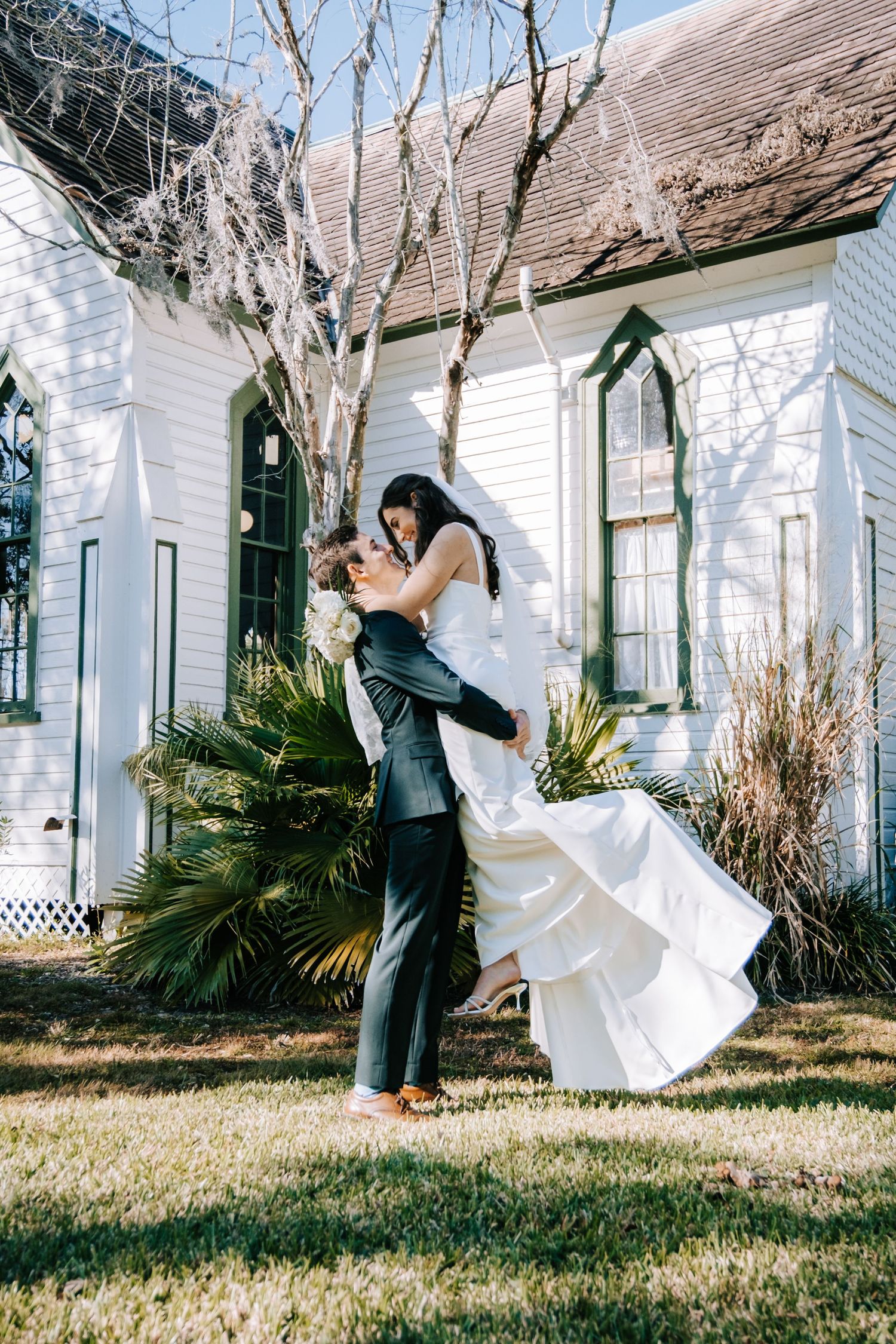 Joyful wedding first look moment captured in sequence outside a white colonial style building.