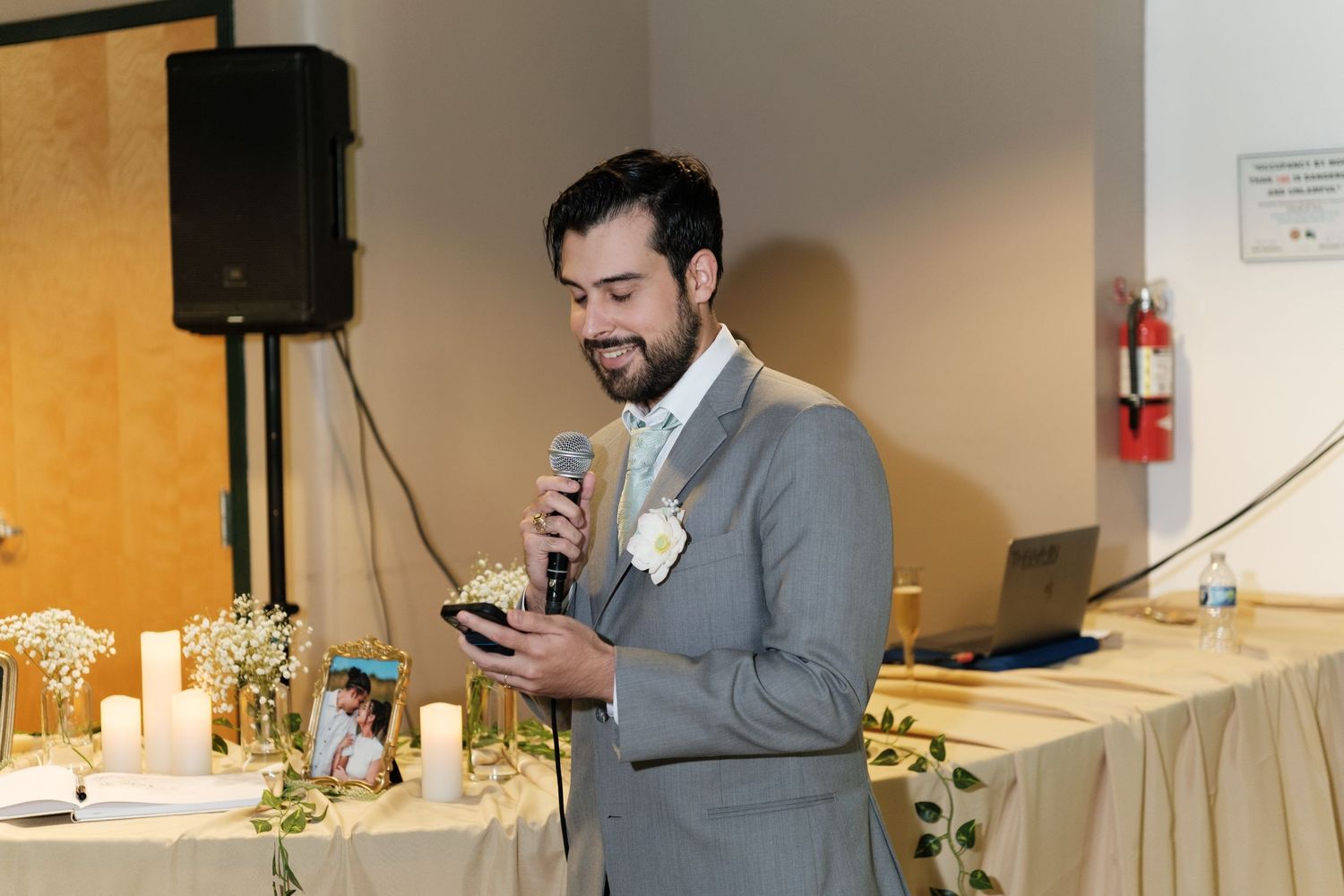Indoor wedding ceremony with speakers and lighting equipment.