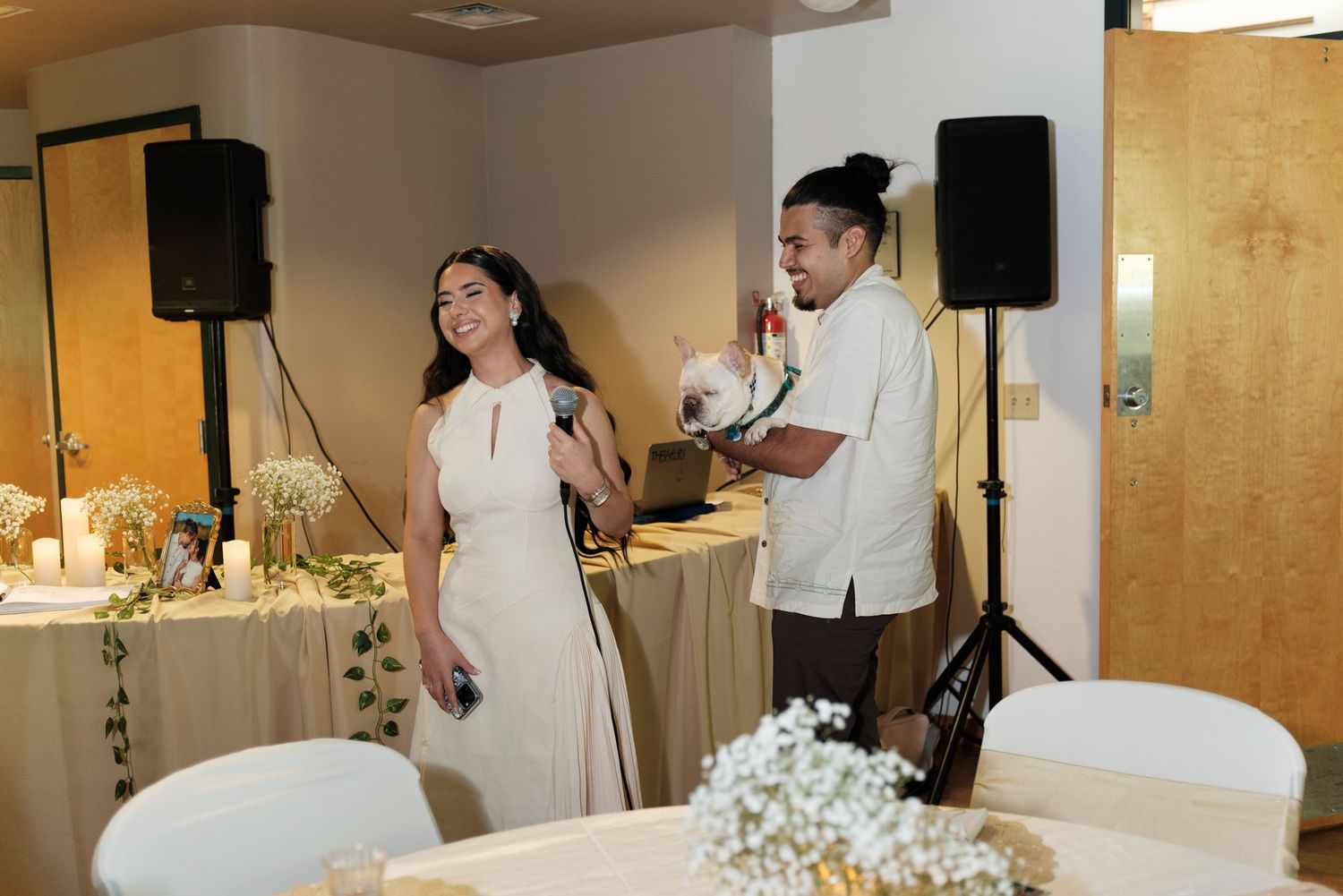 Wedding reception venue with speakers and decorative lighting setup.