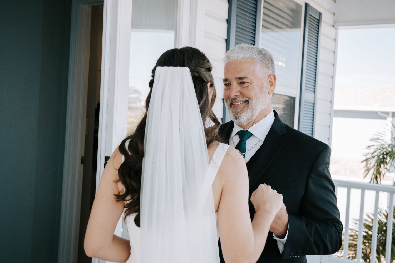 First look wedding photography sequence on a bright porch with natural lighting.