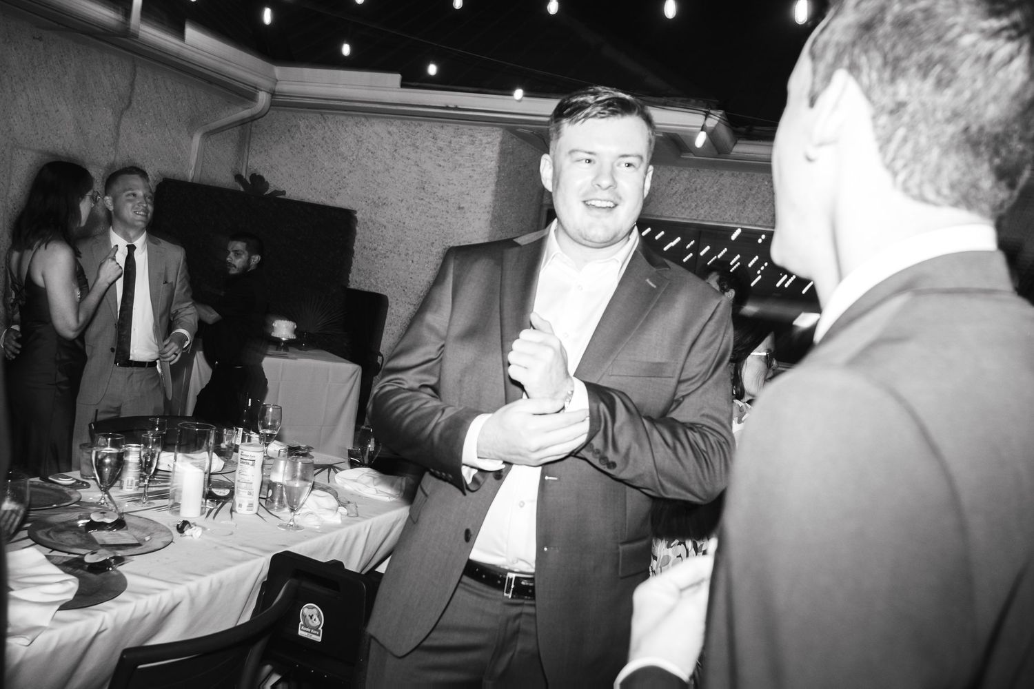 A sequence of black and white photos showing guests socializing at a formal event with drinks and conversation.