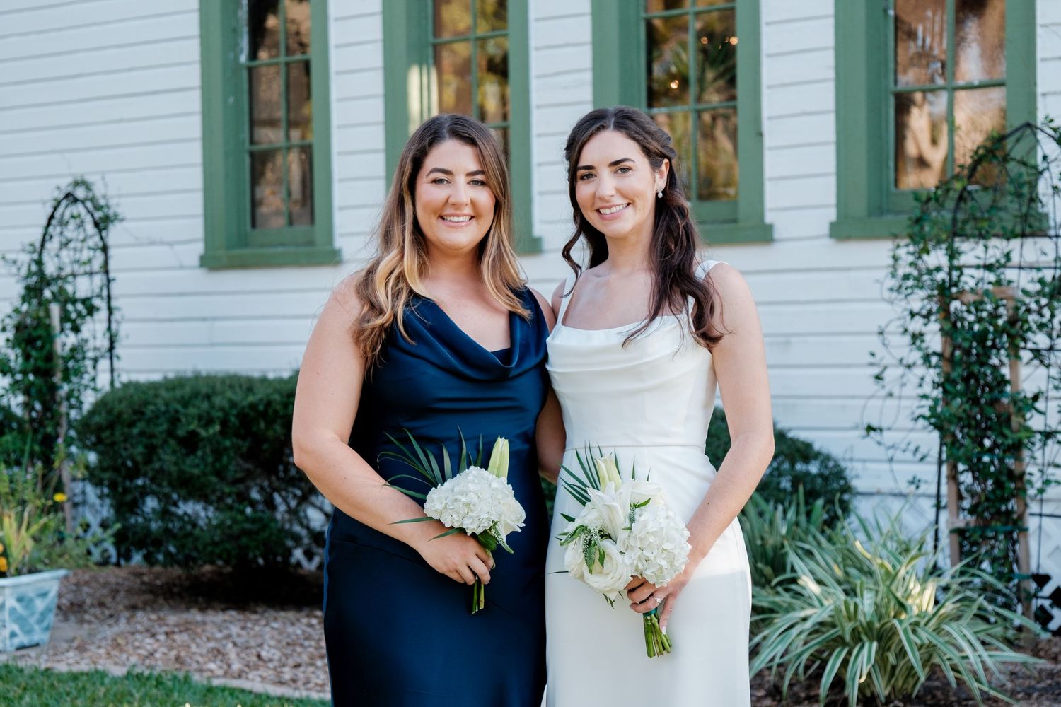 A series of wedding party photos with bridesmaids in navy blue dresses posing with the bride.