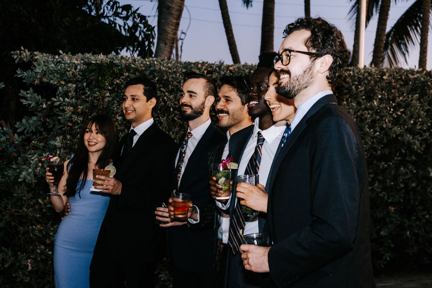 Wedding guests mingling and socializing at an outdoor evening reception.