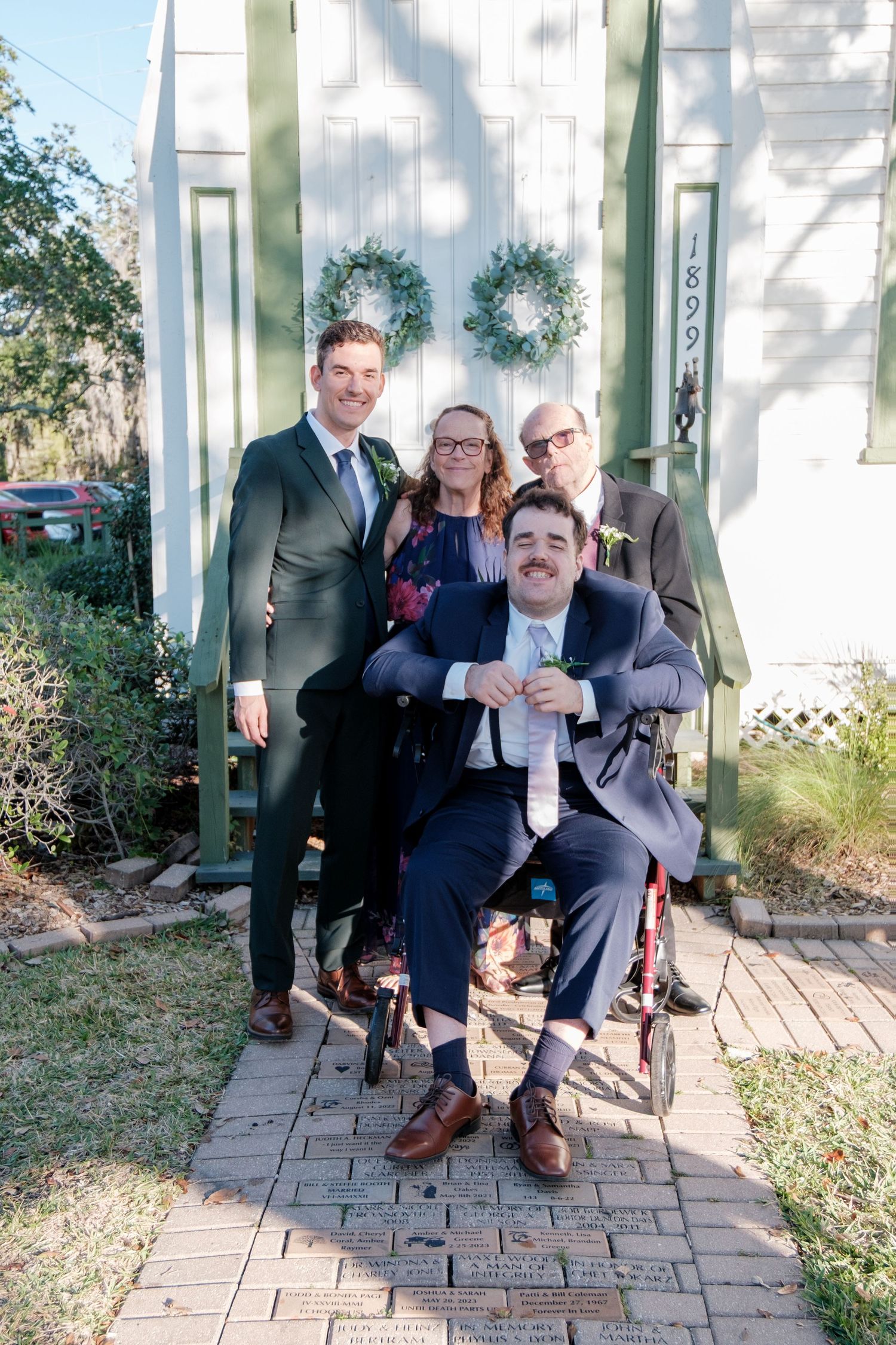 A series of playful wedding party photos taken on a patio with brick pavers and white columns.