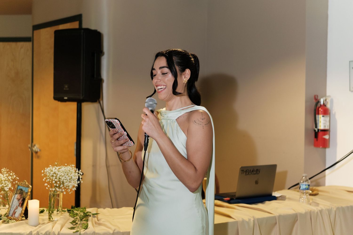 Wedding ceremony space with audio equipment and decorative elements.