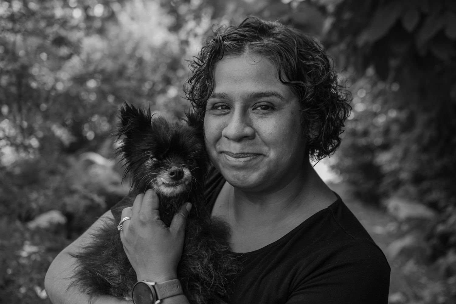 A series of black and white candid portraits showing a person with curly hair in various emotional expressions.