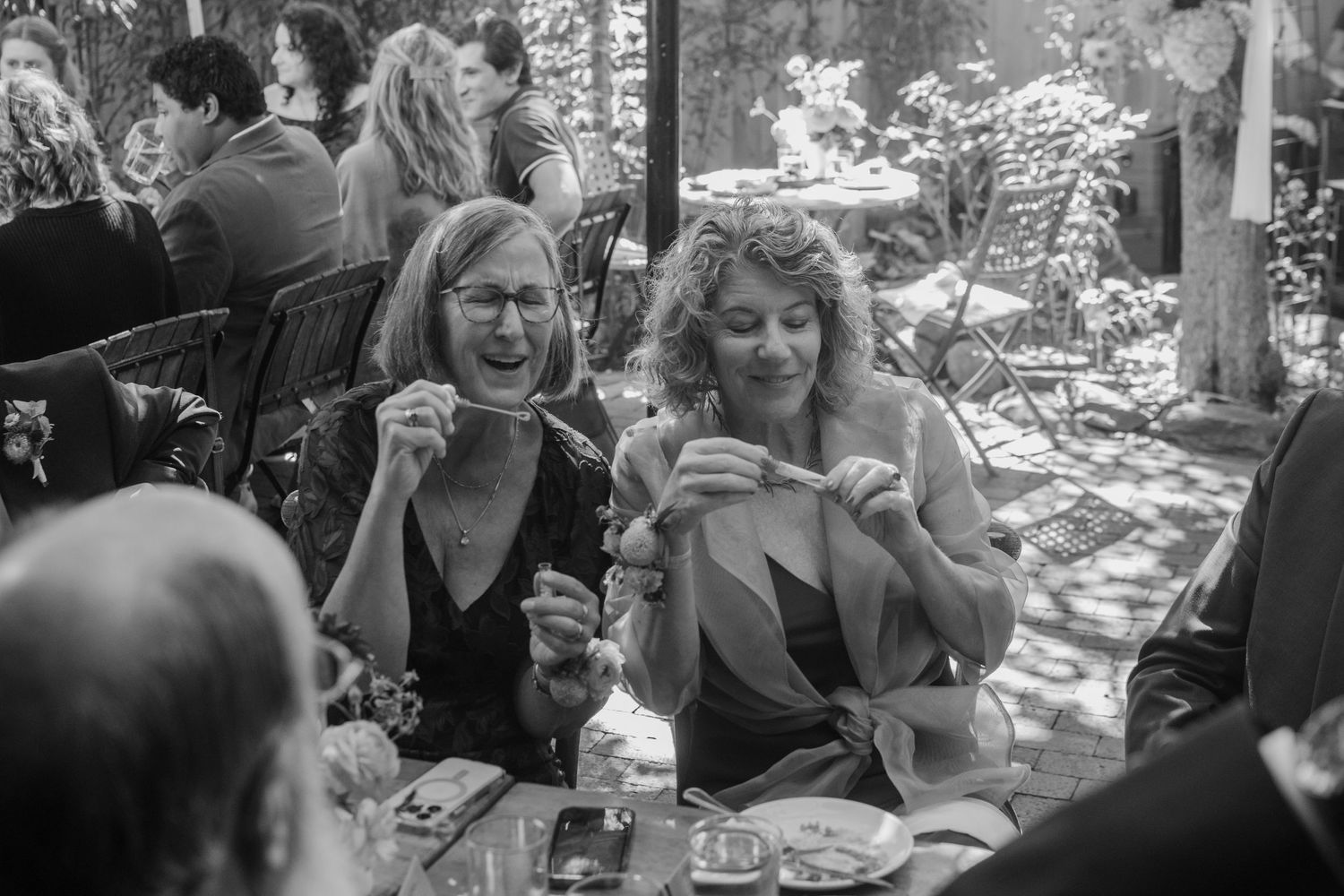 A black and white photo series showing people enjoying drinks and conversation at an outdoor gathering.