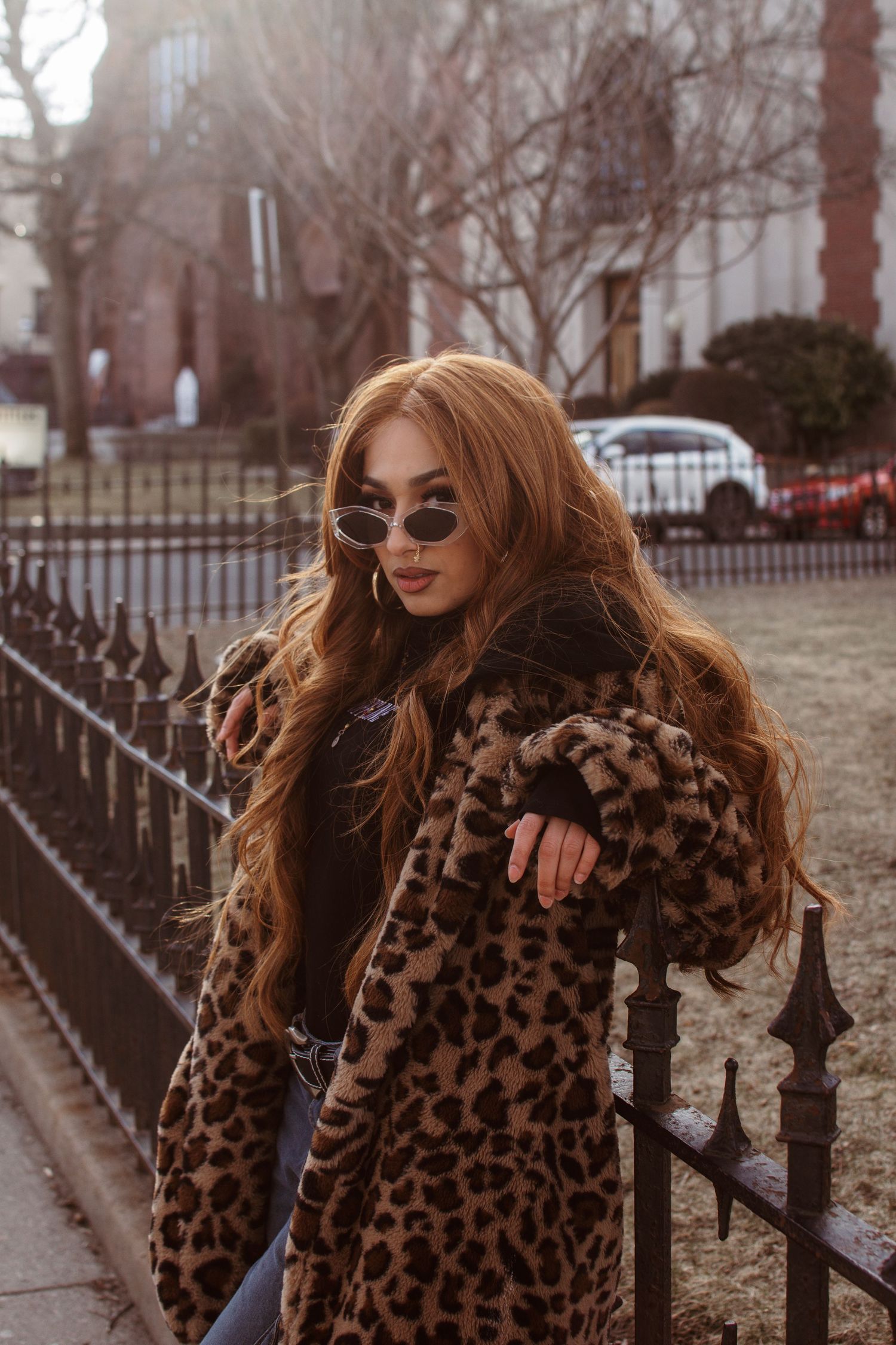 Three fashion photos showing a brown leopard print coat styled with denim and accessories on a winter street scene.
