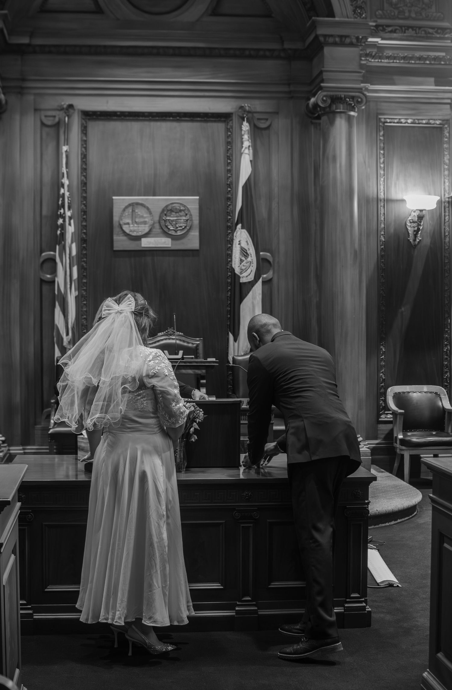 A sequence of black and white photographs showing a nun and man interacting in what appears to be a courtroom setting.