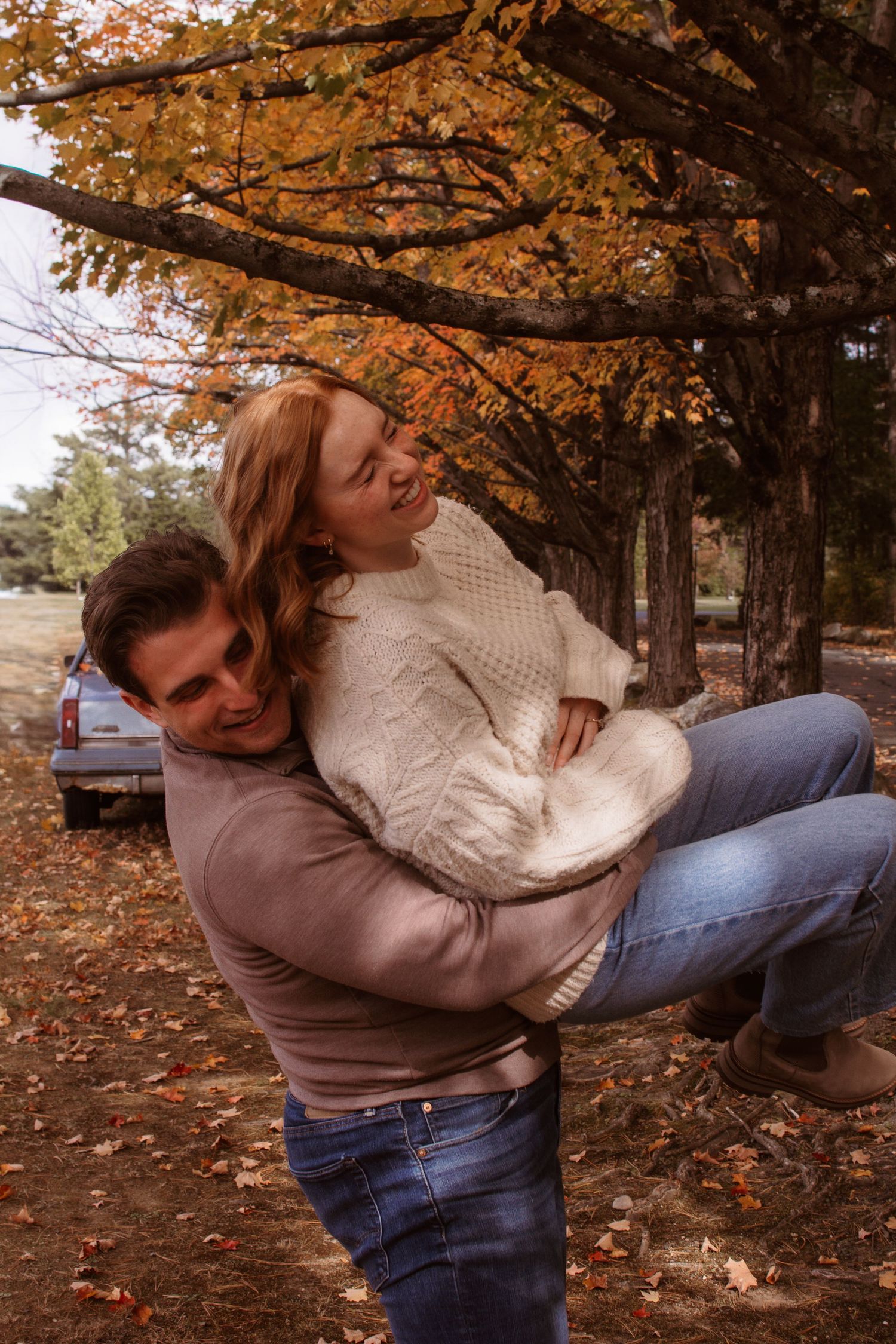 A playful autumn photoshoot sequence shows someone spinning and twirling under trees with orange fall foliage.