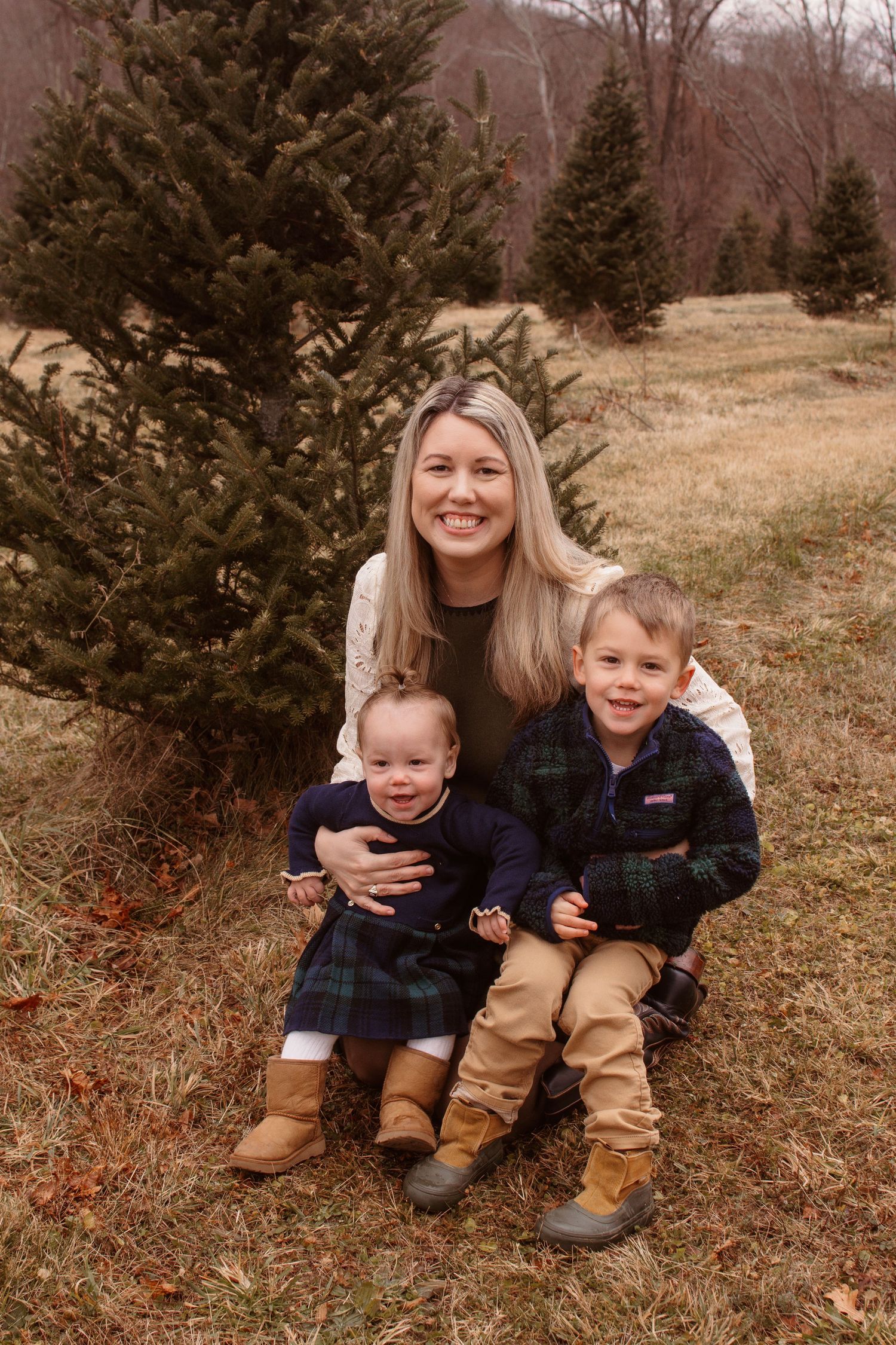Candid family photos at a Christmas tree farm show joyful moments between parent and child in winter clothing.