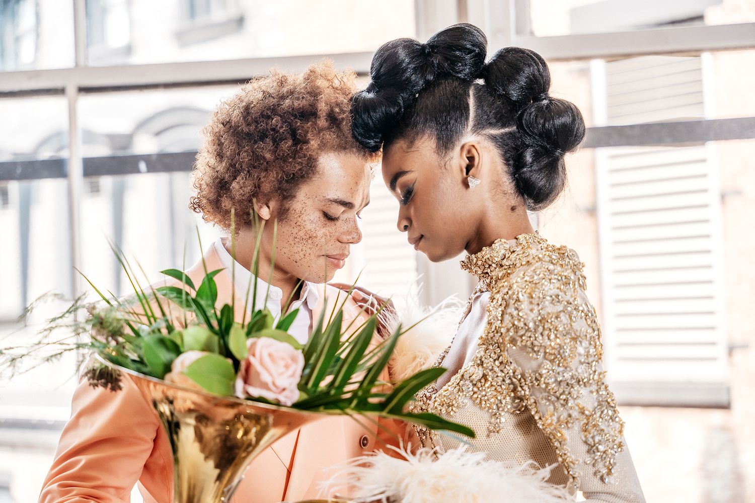 Romantic floral photoshoot with elegant attire and peach roses in an urban setting.