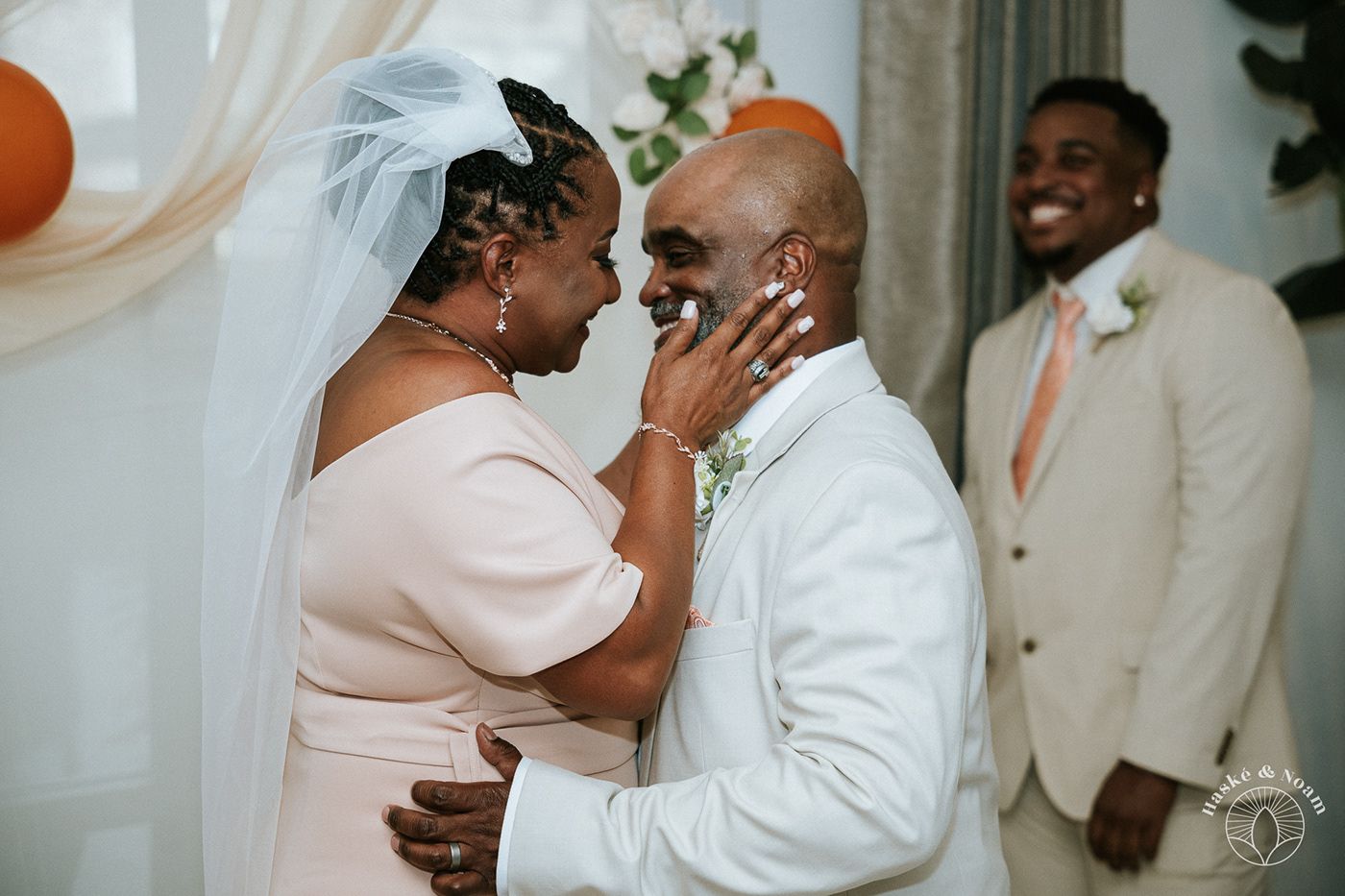 Wedding couple sharing an emotional moment during their ceremony.