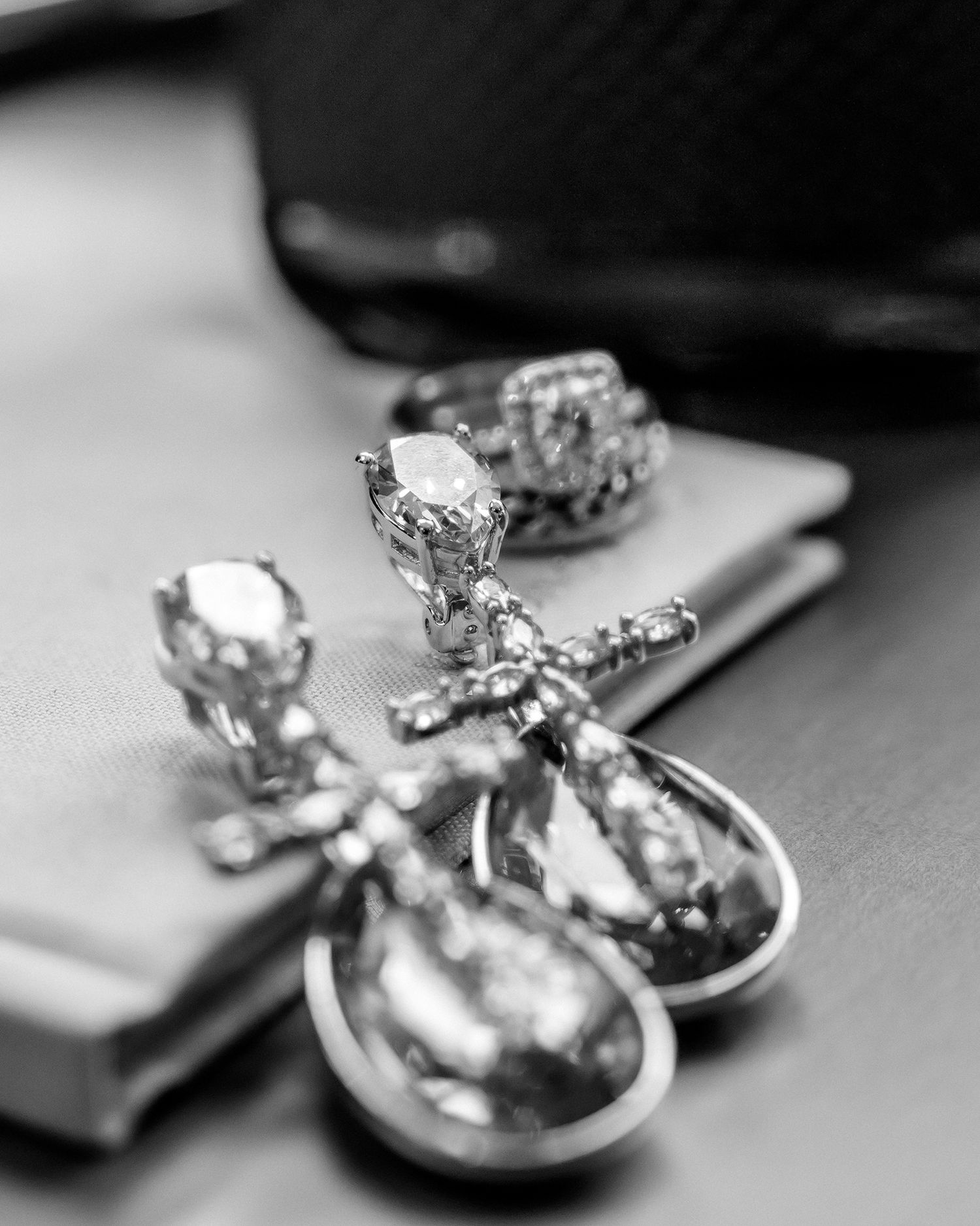Close-up of vintage-style crystal drop earrings in black and white.