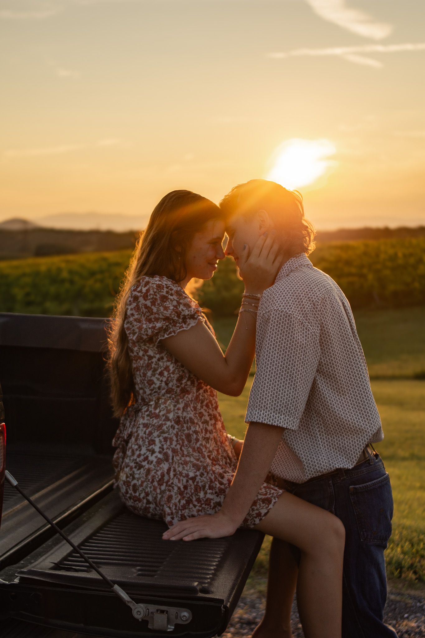 Couple posing on truck bed with fading sunset. 
@addykayphotography 2025.