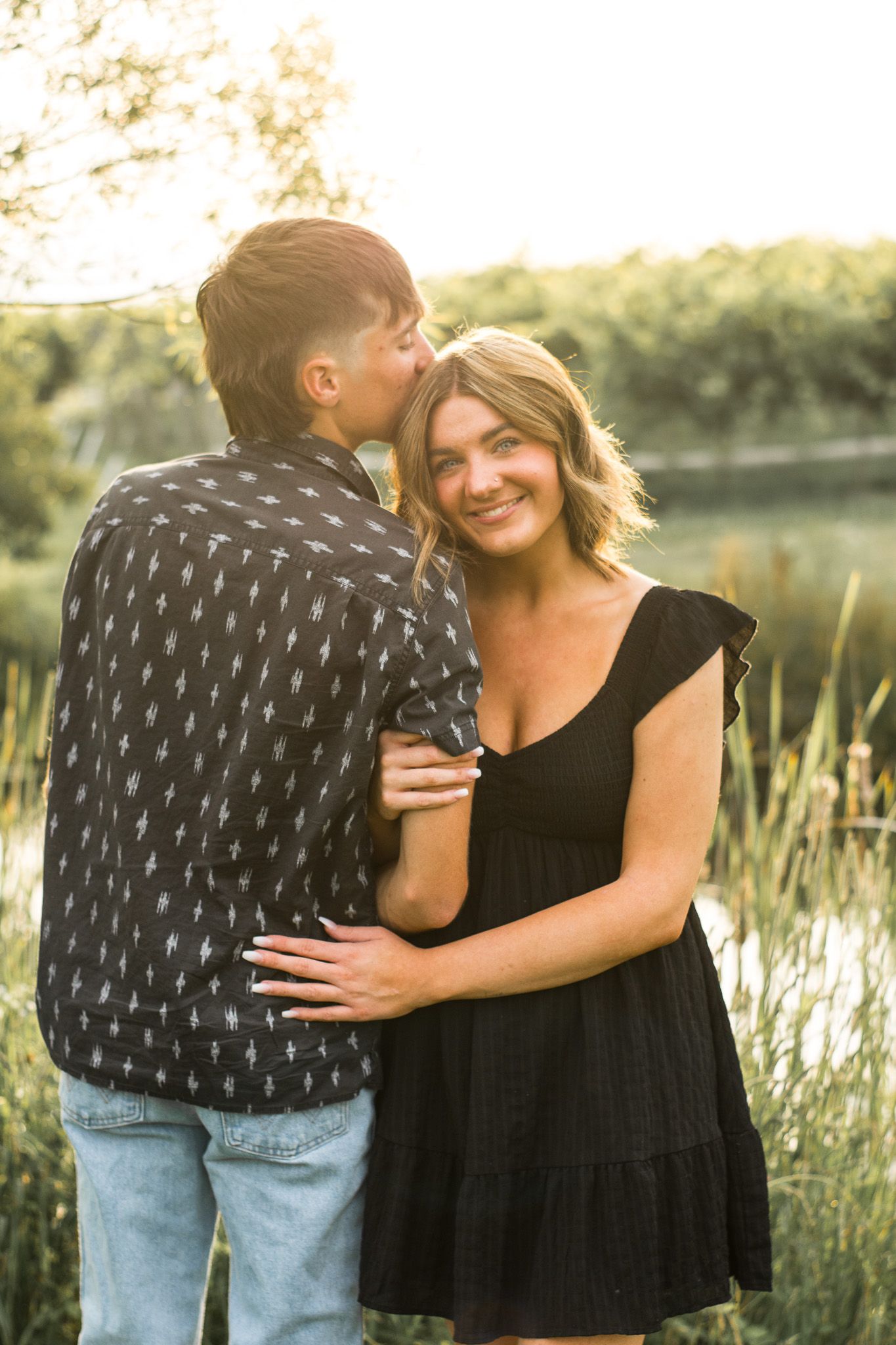 Couple pose in front of a pond at sunset.
@addykayphotography 2025.