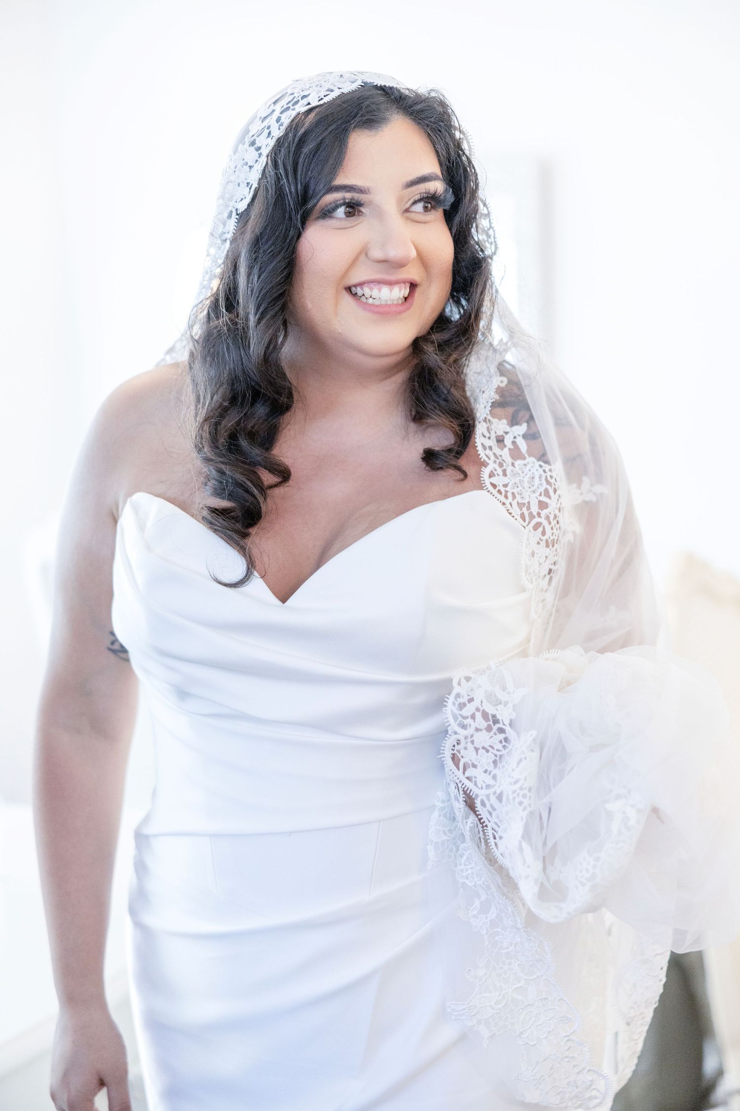 Elegant white lace wedding dress captured in natural light.