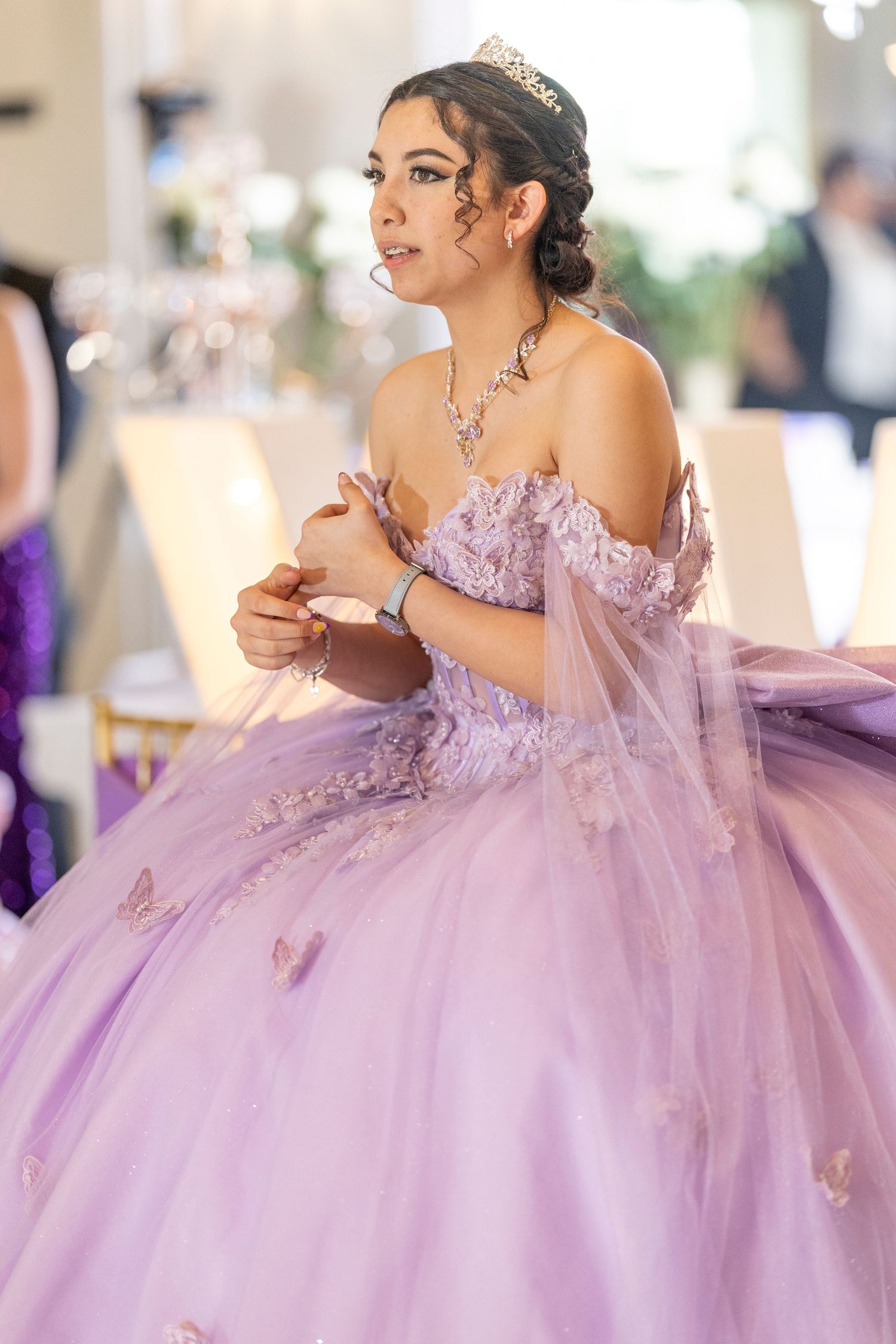 A stunning lilac quinceanera dress with butterfly details and full tulle skirt creates an ethereal princess look.