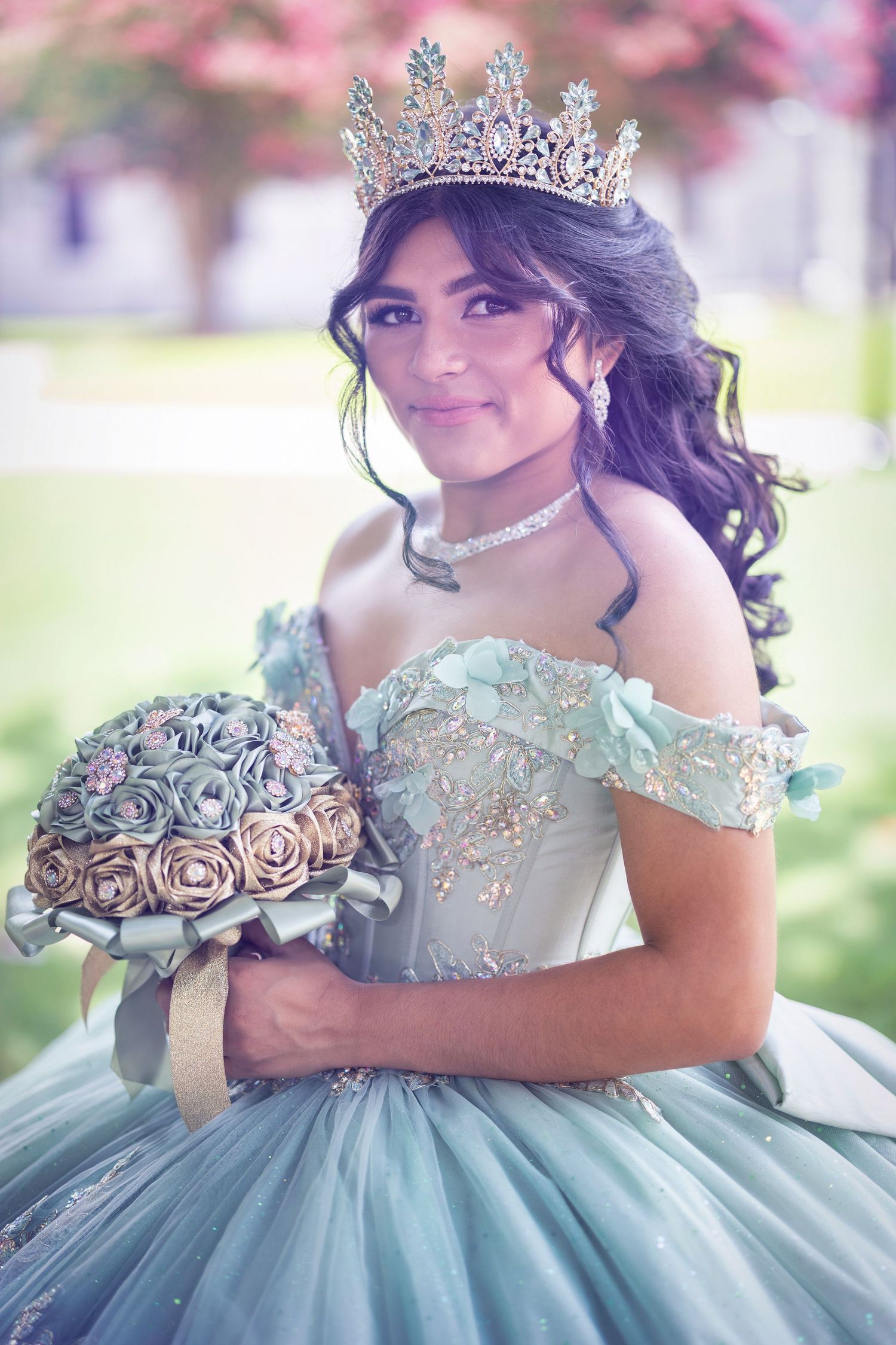 A stunning quinceañera dress in soft blue with ornate beading, ruffled off-shoulder details and a voluminous tulle skirt.